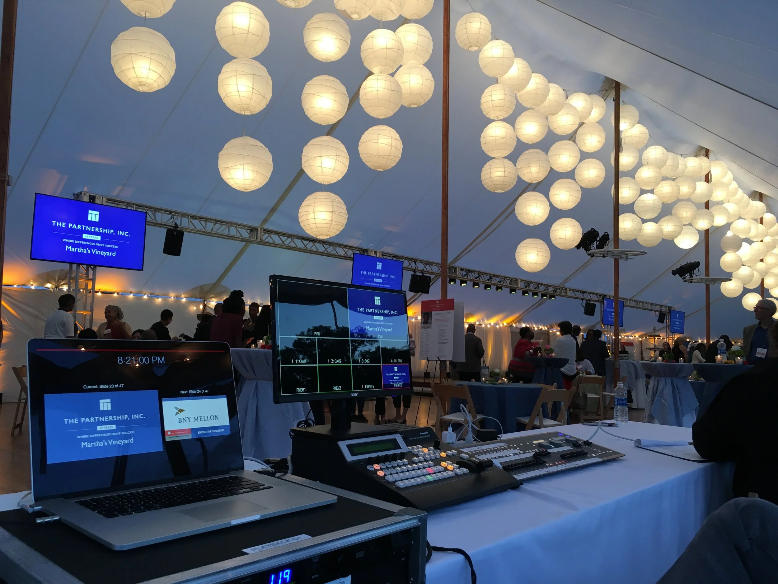 Video screens, audio and lighting supported by a truss structure for a diversity summit