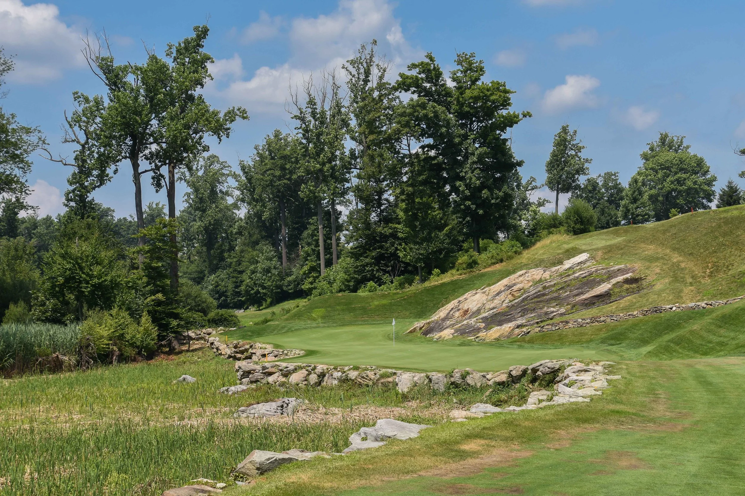 The 15th green at Pound Ridge offers an opportunity for the rare bank it off the rock birdie. 