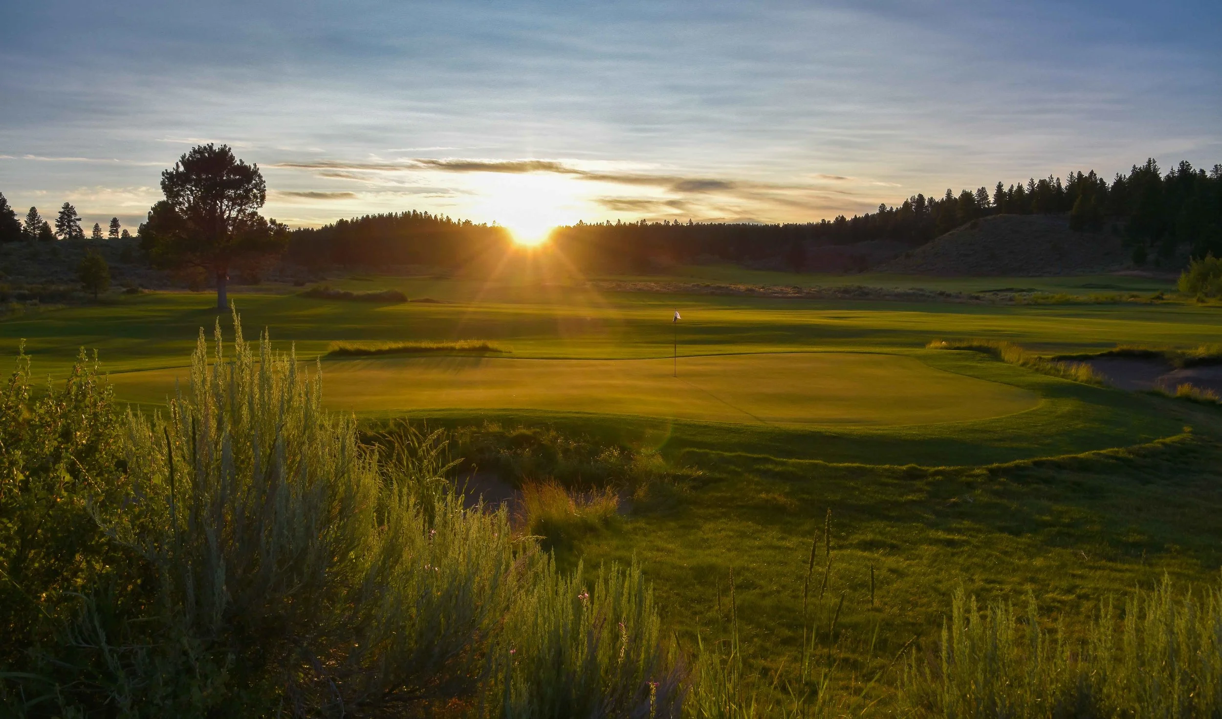 The sun sets over #16 on the Craddock course.