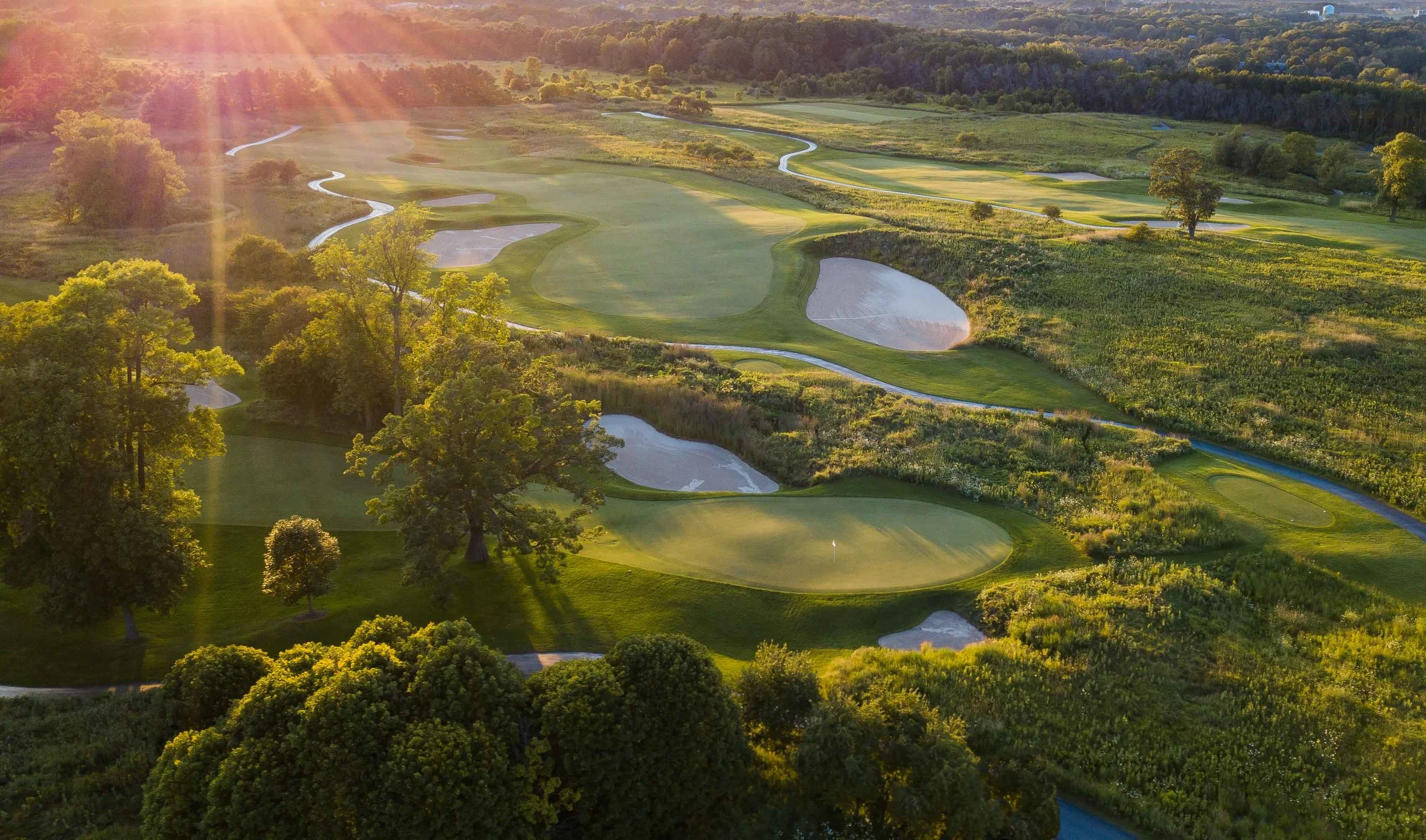 The last of the day’s sun splashes down on the Meadow Valleys Course at Blackwolf Run.