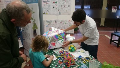 Pictured in the middle, is a prototype constructed by the VRICKs team, created using the laser cutter. The project was presented at the Science Festival in Norwich along with Roger’s PhD project on viral structures (pictured in the left). Photo Credit: Roger Castells