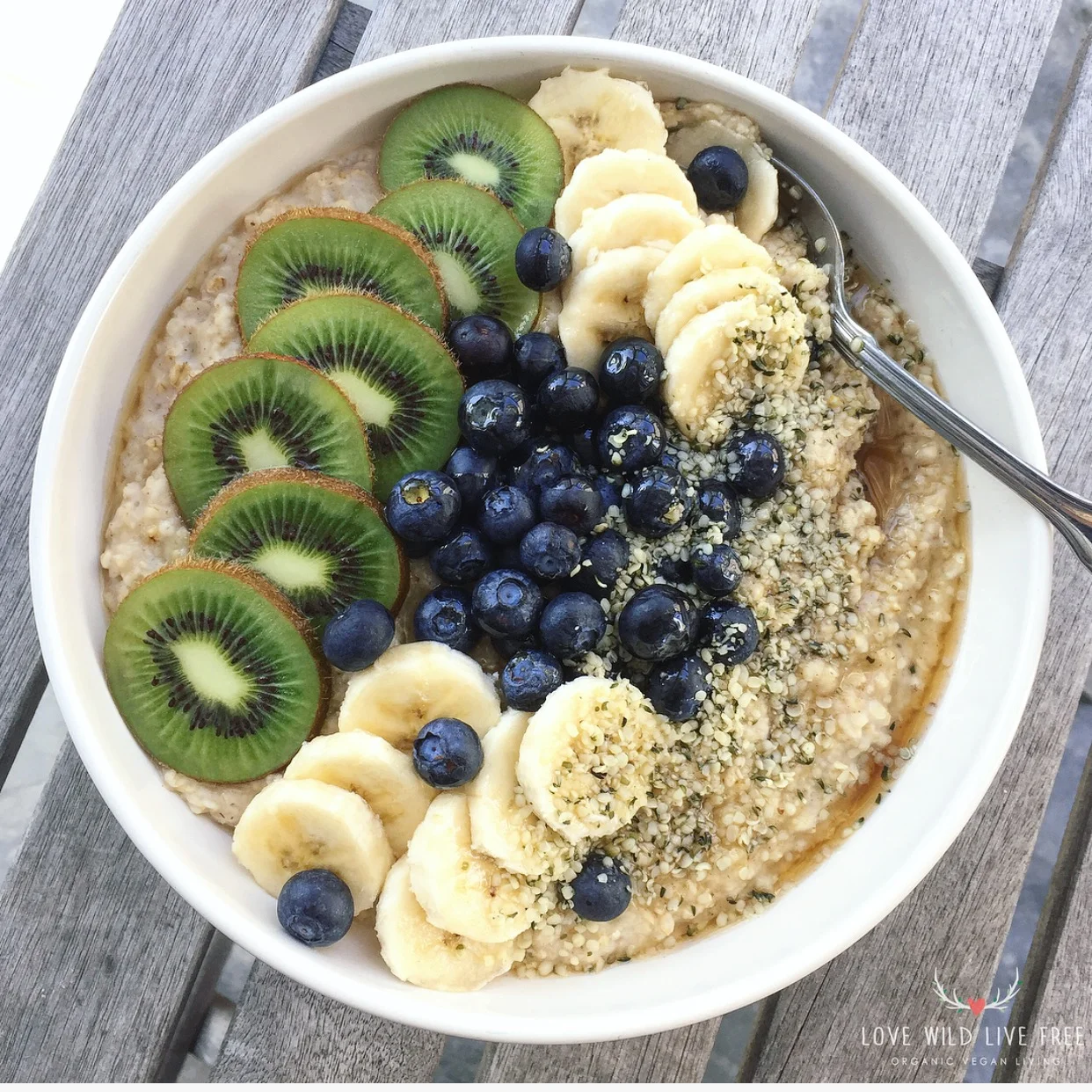 Quick + Easy Vegan Oatmeal topped with fresh kiwi, blueberries, bananas, pure maple syrup and Manitoba Harvest hemp hearts .
