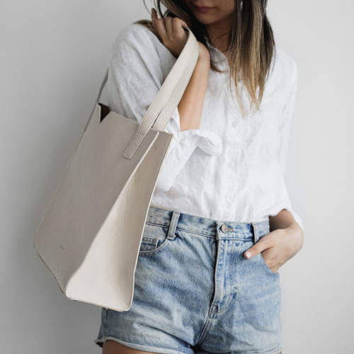 The Alicia Soft Tote in Cream by Pixie Mood is a soft tote bag, made with vegan leather. Photograph by Pixie Mood. 