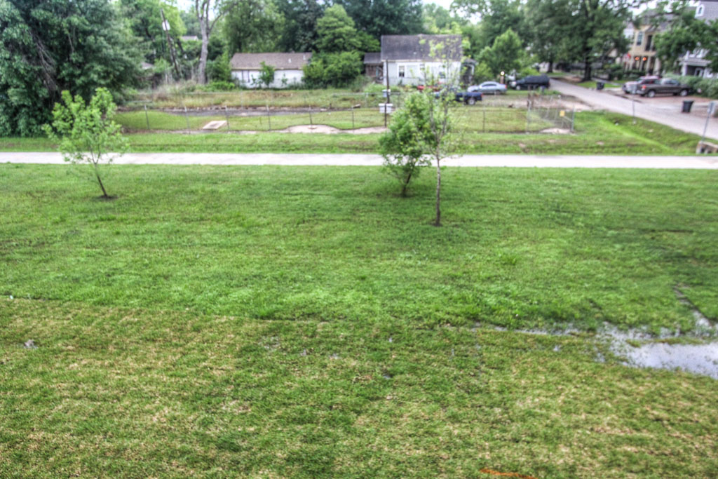 Welcoming deep front porch. This is an inviting area where you can sit and enjoy an uncommonly large greenspace for this part of the city.