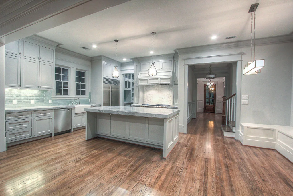 The kitchen and breakfast area, both open and functional, are the heart of the downstairs living area. This area connects to both the formal dining and butler's pantry as well as the great room and guest quarters.