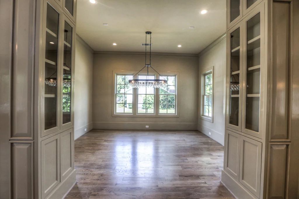 The entrance to the sunny dining room is flanked by built-in china cabinets, and it has an entrance to the first-floor porch. This room, along with the entire downstairs living area, boasts 11' ceilings.