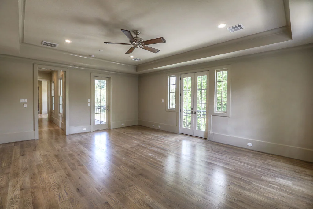 The master bedroom is a sprawling 21' x 18' and has a private balcony overlooking Columbia, as well as shared access to the second-floor porch. The vaulted ceiling and 12" baseboards are some show the builder's signature touch.