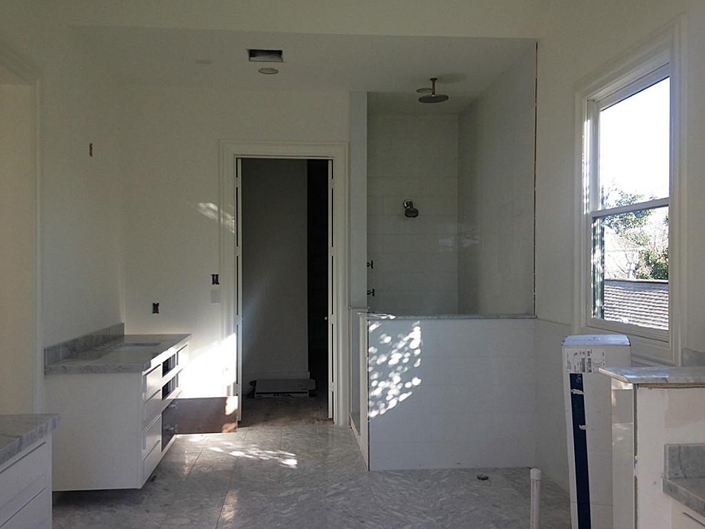 Master bath takes a modern approach to a classic Carrara bathroom look. Combination of whites and light grays create soothing spa like feel.