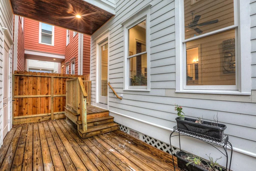 A partially covered deck in the back provides a sheltered pathway to garage. Access is made through mud room.