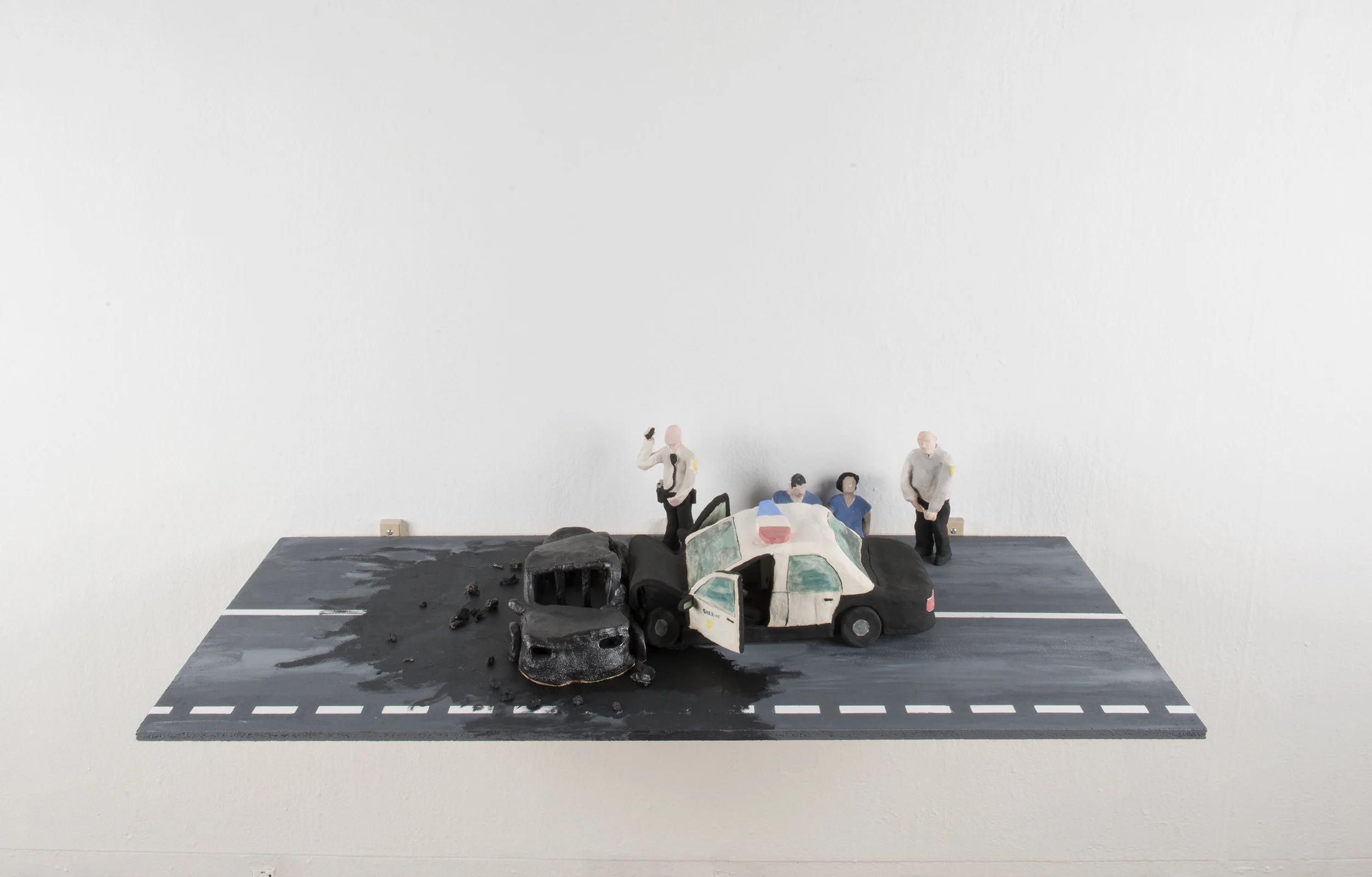 Deadly Crash on the 5 , 8in x 48in x 22in. Ceramics and Acrylic Paint on Plywood. 