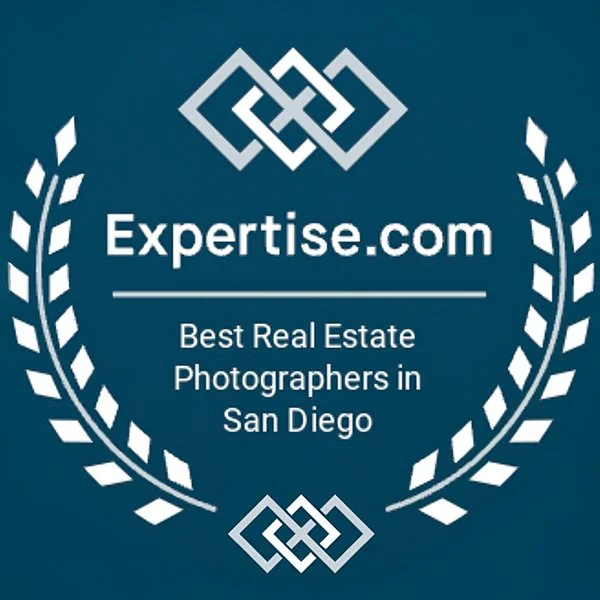 Expertise.com logo with text stating "Best Real Estate Photographers in San Diego" surrounded by a laurel wreath on a blue background.