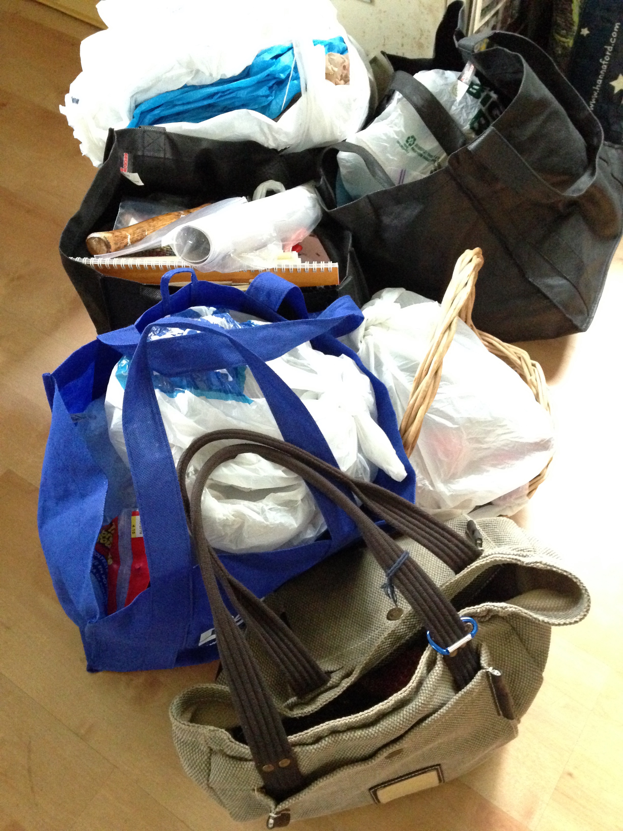 Bags full of temari, handouts, knitting, packaging, bowls and baskets for display, miscellaneous office supplies, knitting patterns, the kitchen sink...