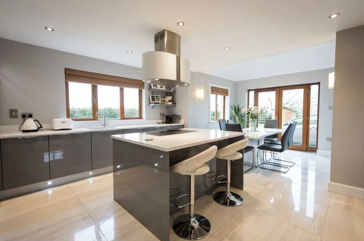 Mineral grey gloss and white quartz make for a sleek and modern kitchen-dining area in this West Waterford home