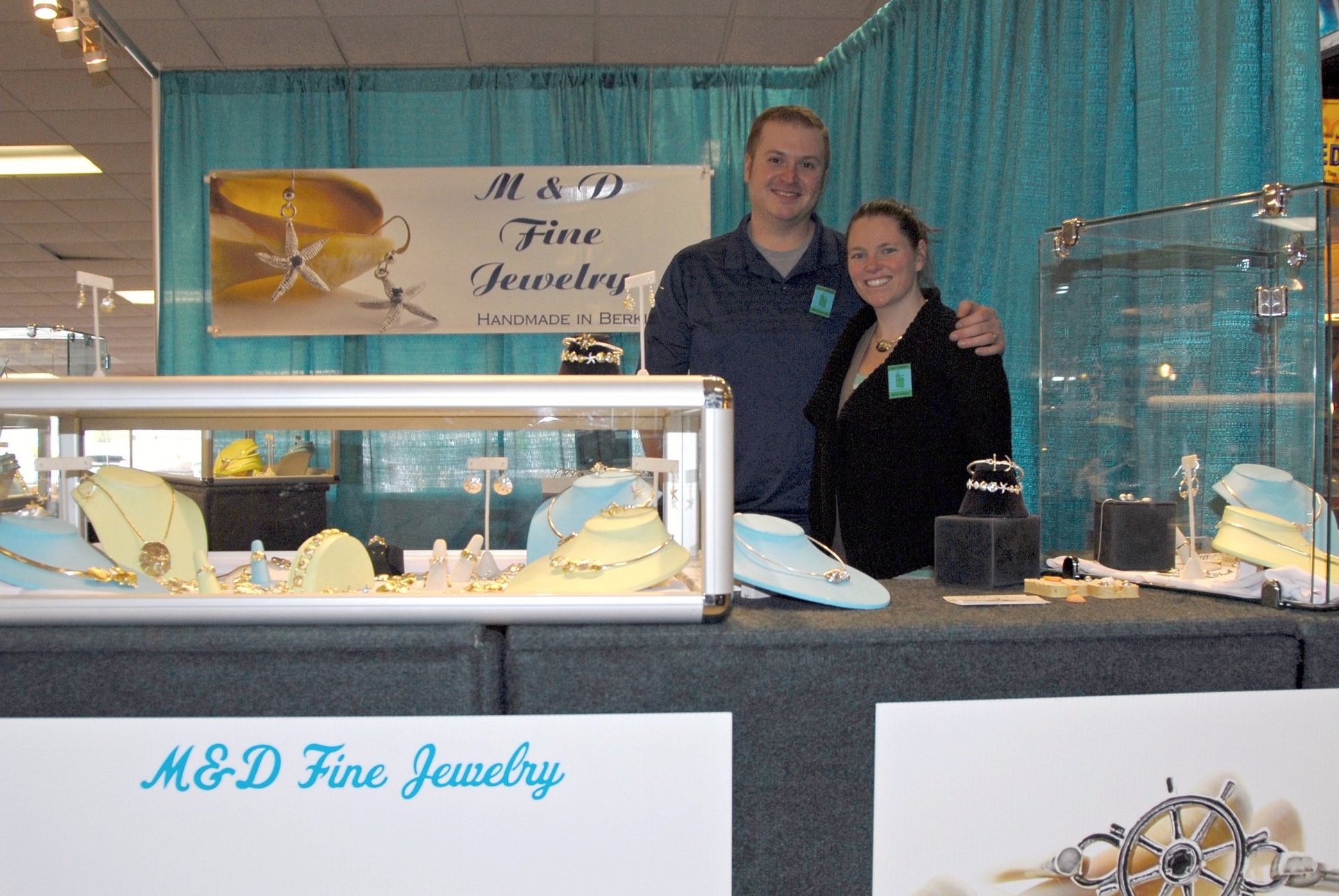 White male and female standing in jewelry booth