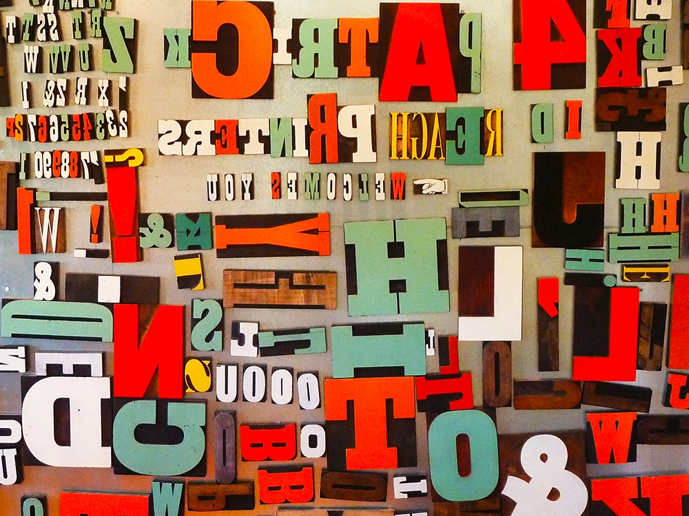 A wall of wood type in the visitors' lounge. The letters are attached magnetically and can be arranged to make personal messages, albeit backwards. 