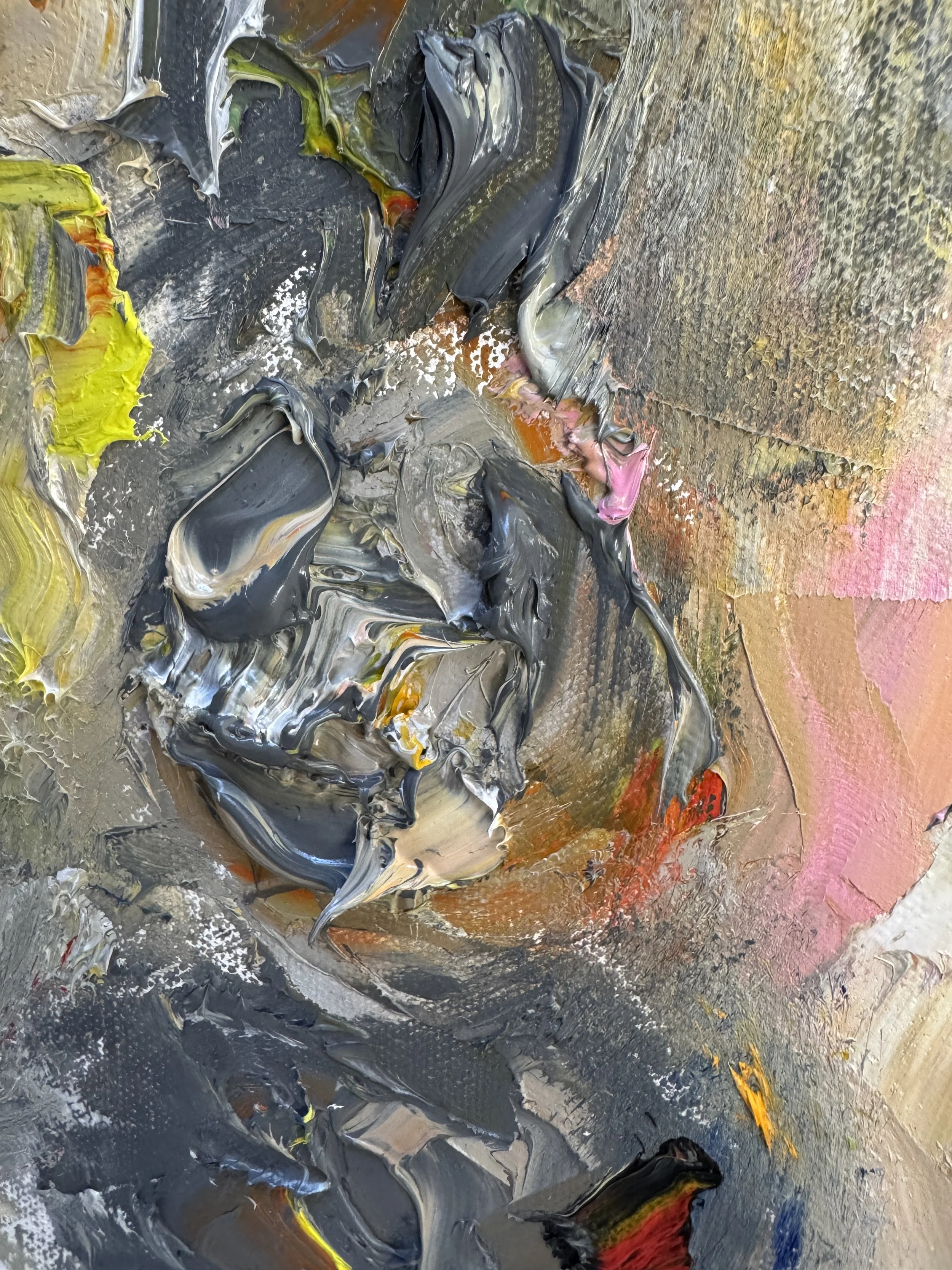 Close-up of textured abstract oil paint with layered strokes in dark and warm tones.