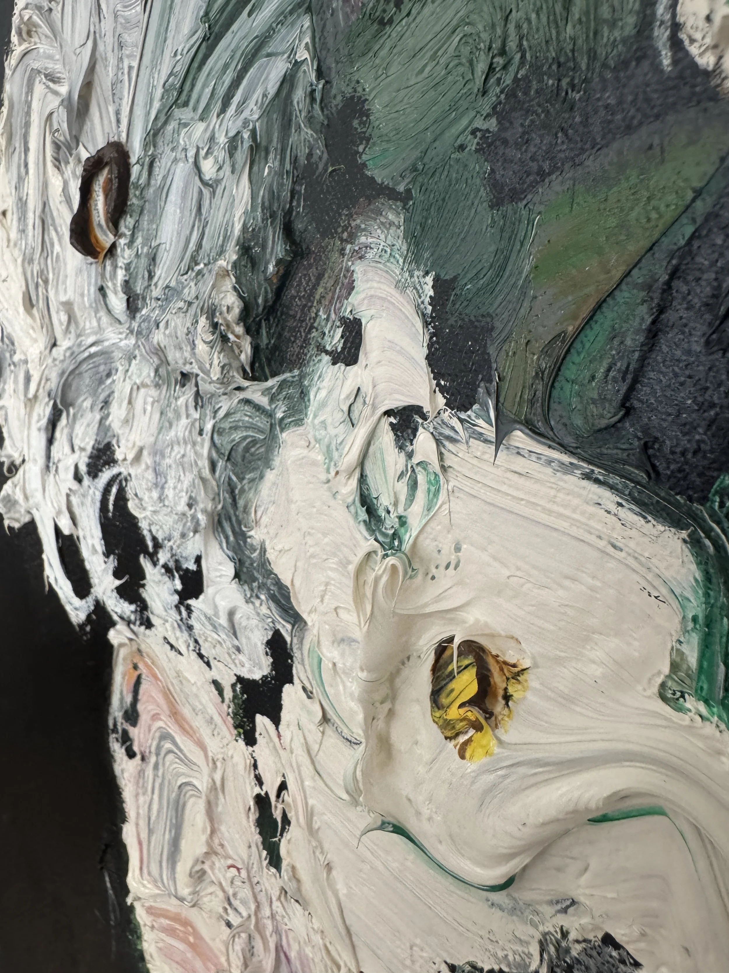 Abstract close‑up of thick oil paint with swirling strokes of white, green, black, yellow, and hints of pink, showing heavy impasto texture.