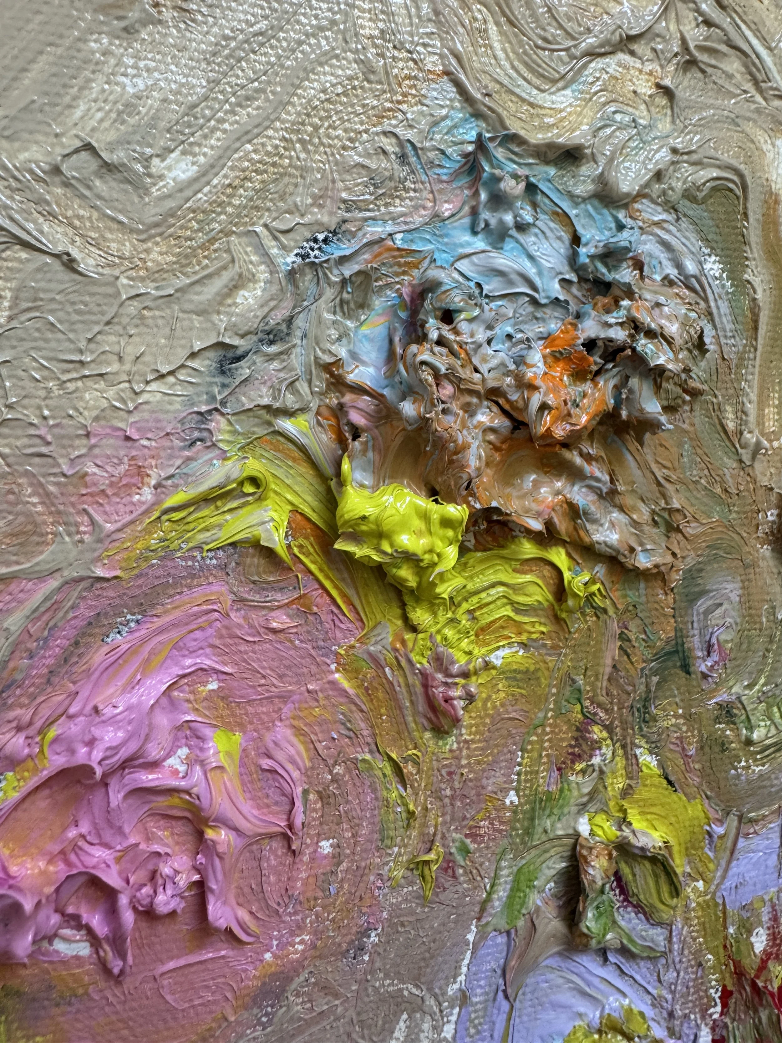 Close up of layered oil paint in beige, blue, orange, yellow, pink, and purple with heavy palette knife texture.