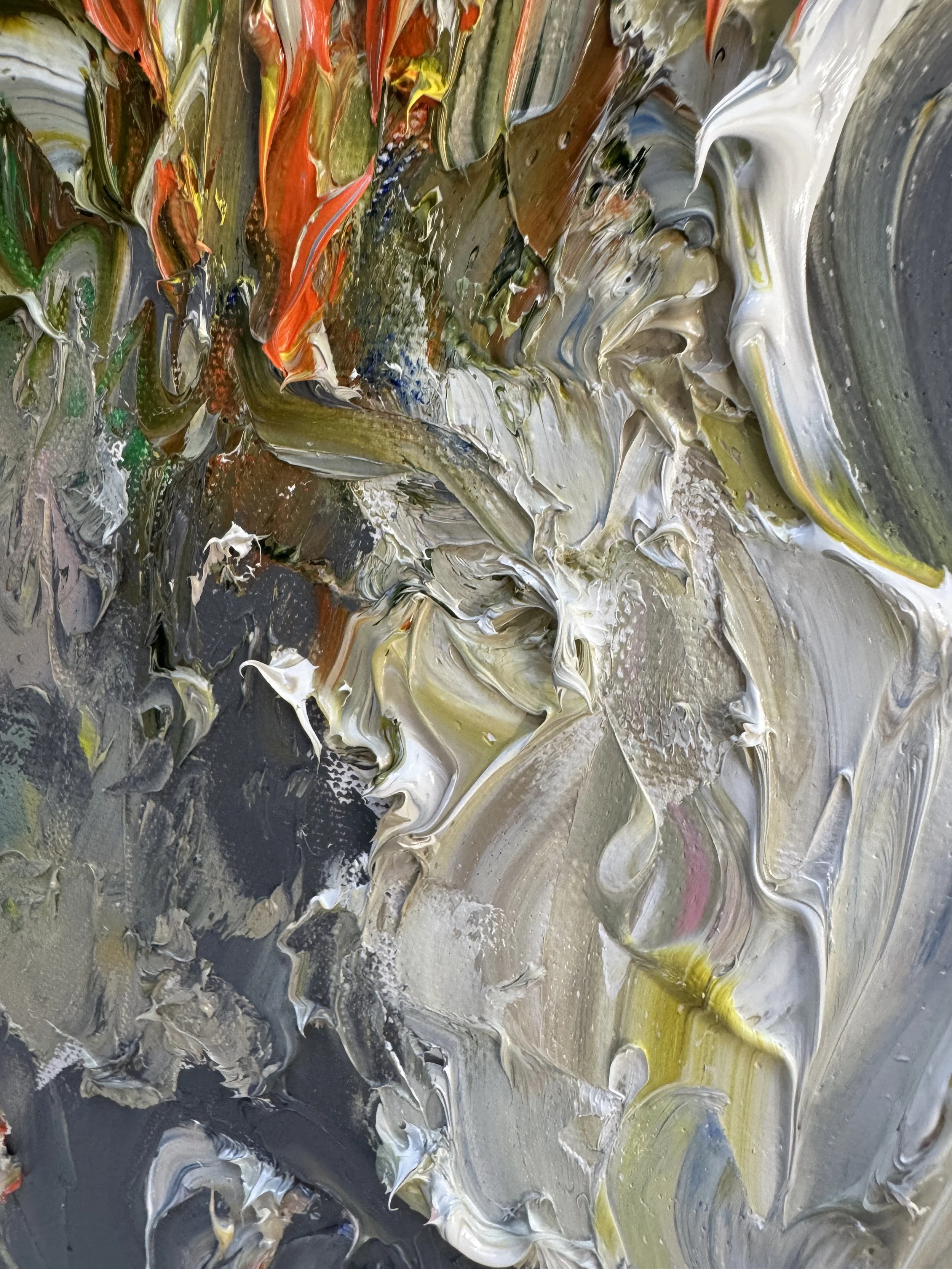 Abstract oil paint close-up with heavy texture and blended multicolor strokes.