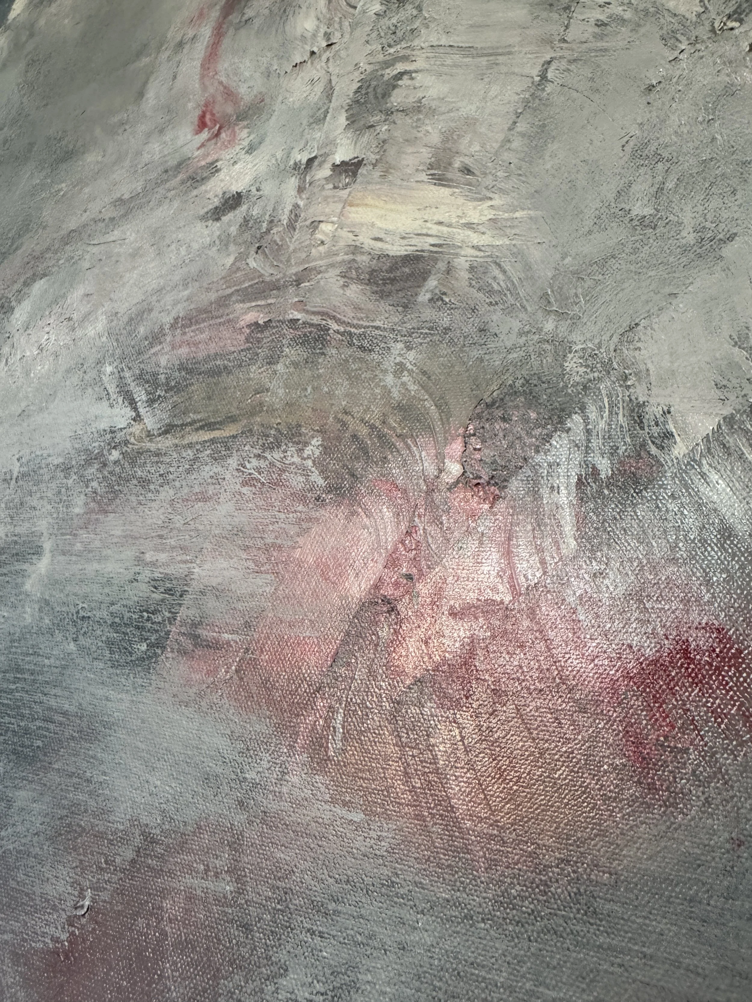 Textured abstract painting with layered brushstrokes in gray, white, and pink; warm tones contrast cool surface.