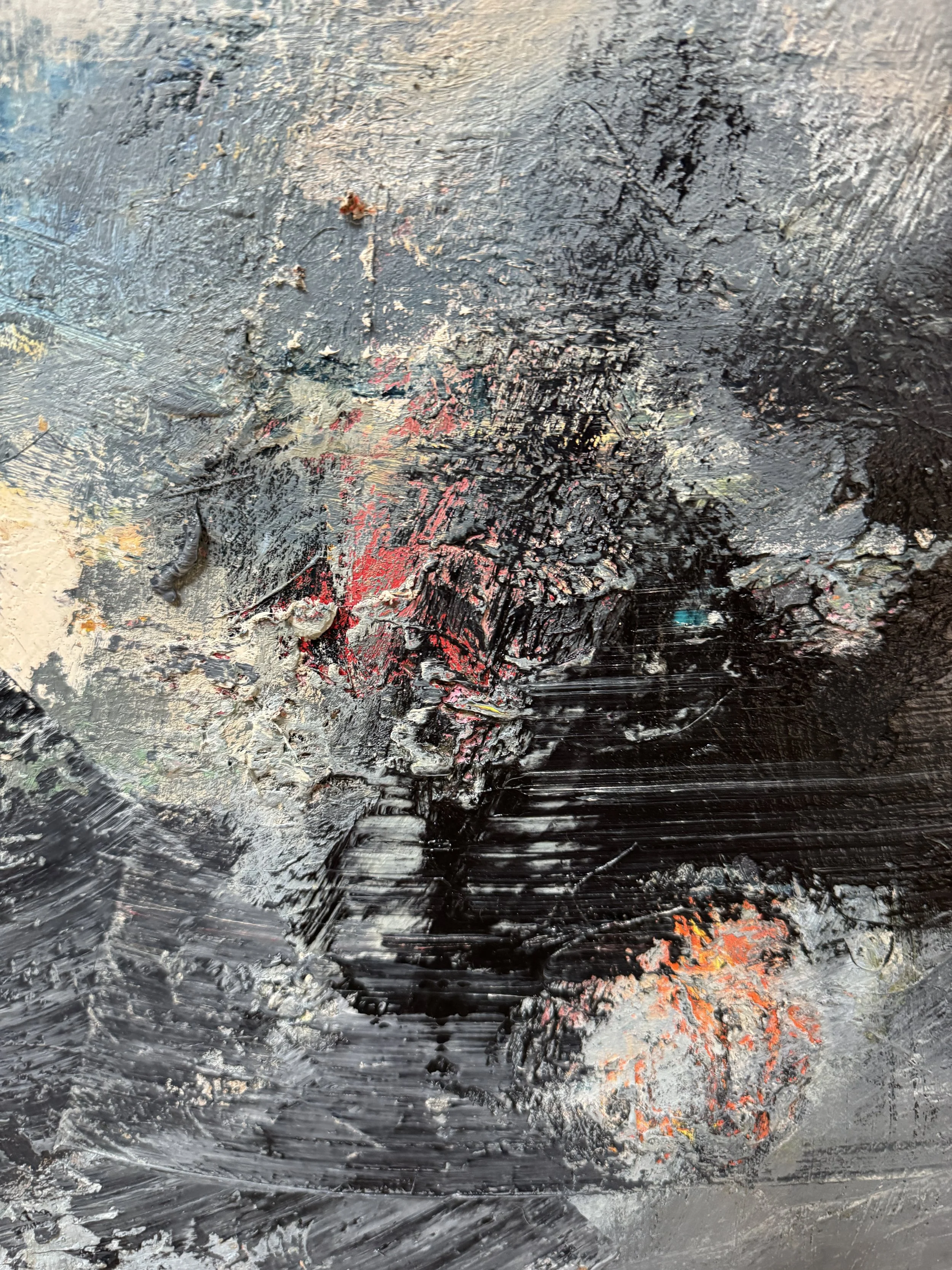 Close-up of layered abstract painting with thick black, gray, and white brushwork, highlighted by red, orange, and subtle blue accents.