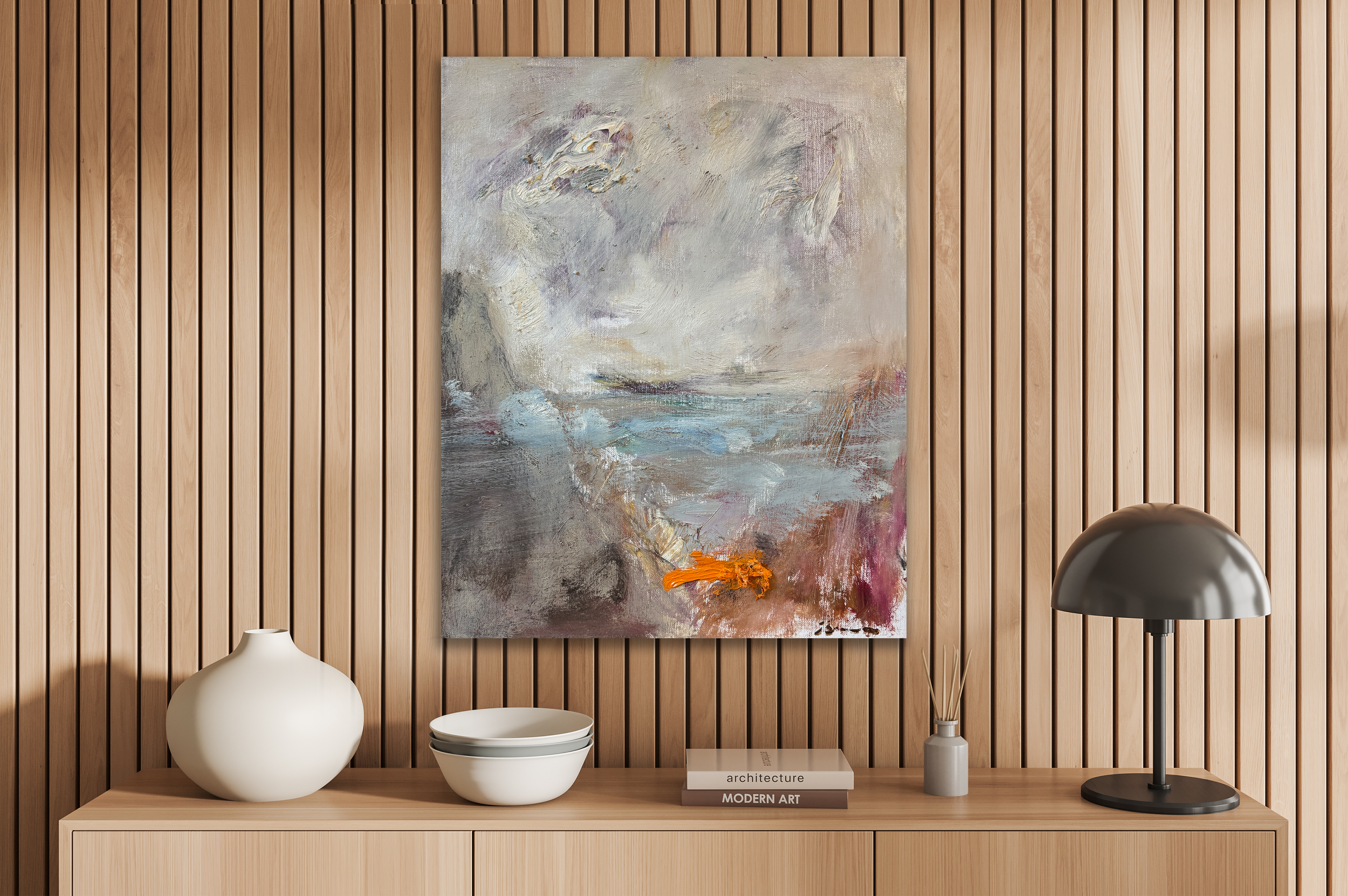 Modern console vignette with slatted wood wall, abstract neutral painting, and minimalist decor including ceramic vases, stacked books, and a black dome lamp.
