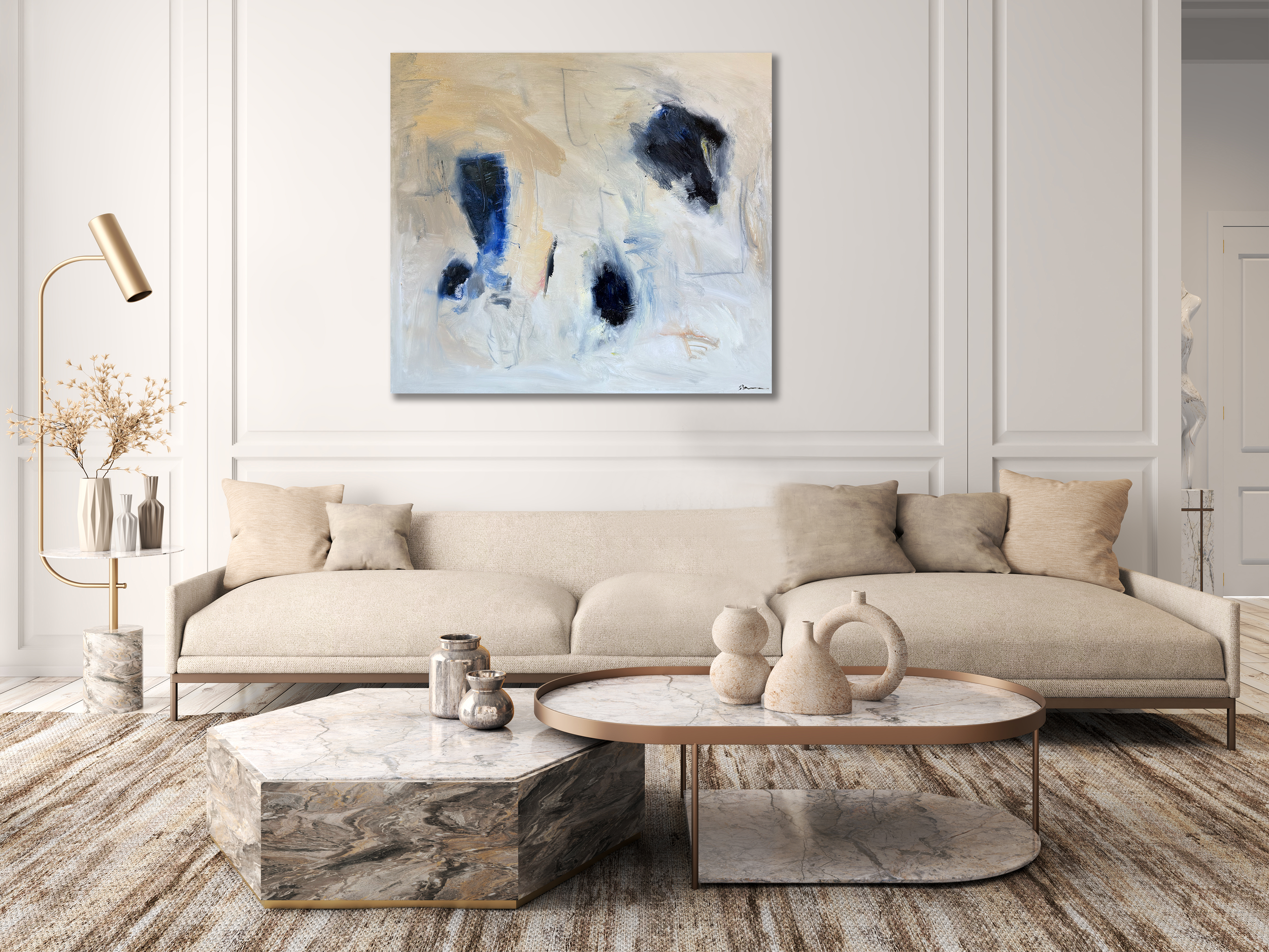 Neutral modern living room with beige sofa, marble coffee table, gold floor lamp, and abstract blue‑and‑beige painting.