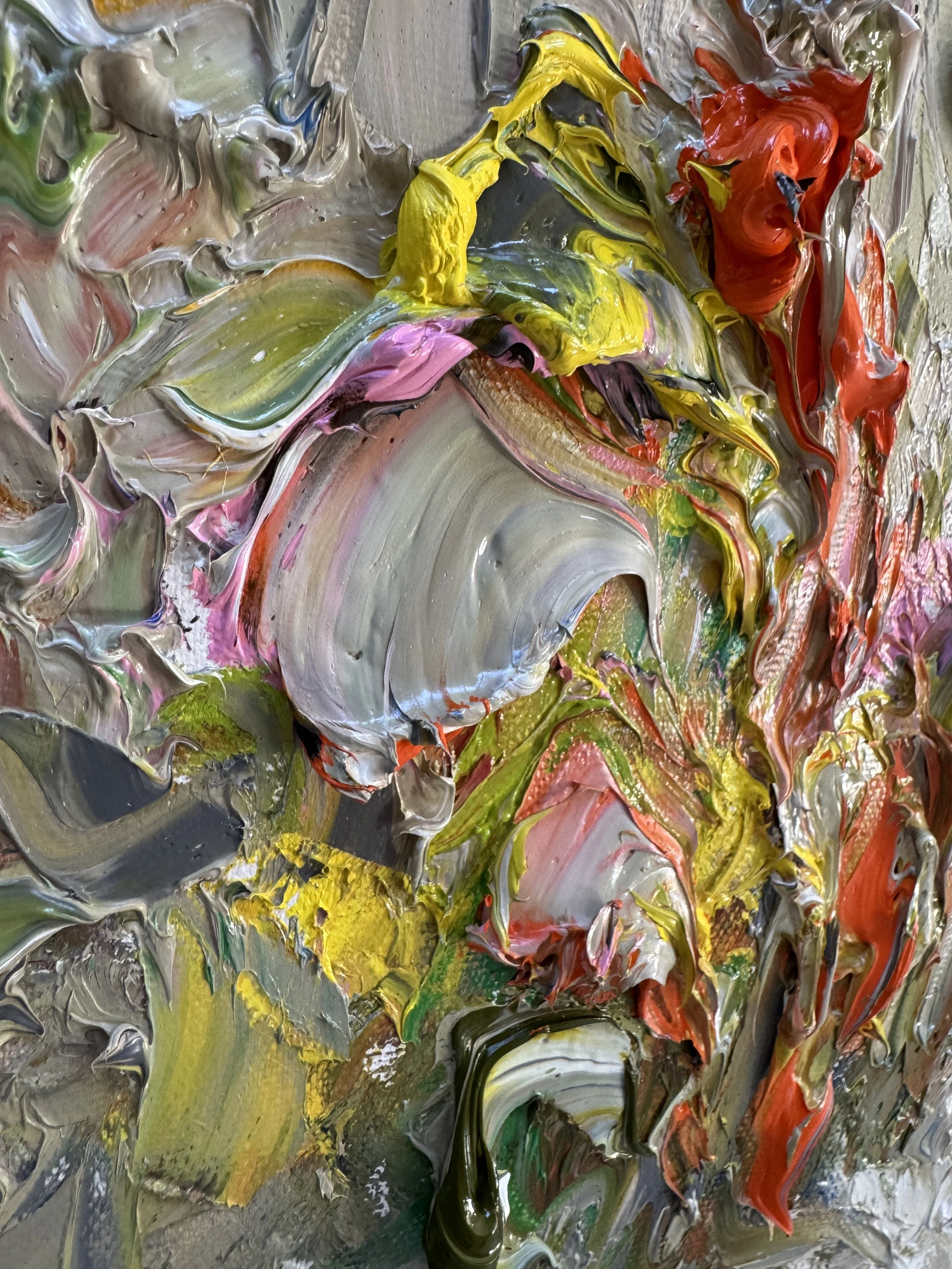 Close-up of thick, textured abstract oil paint in vibrant mixed colors.