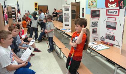 Gavyn Jackson (foreground) and Carter Jackson (background) help Landon Larocca and Rylee Adams fill out their questionnaire sheets on the geographical areas of Australia.