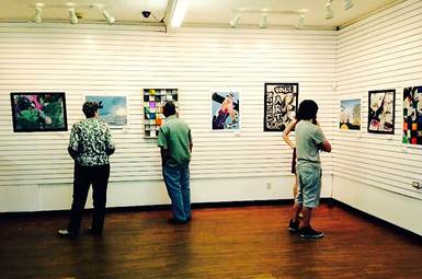 Guests view North Lamar student art at NXS Gallery in Downtown Paris.