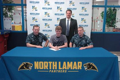 Chase Allen, center, with Petty Officer Sam Money, left, Petty Officer Christopher Gault, right, and NLHS Principal Clint Hildreth, standing. 
