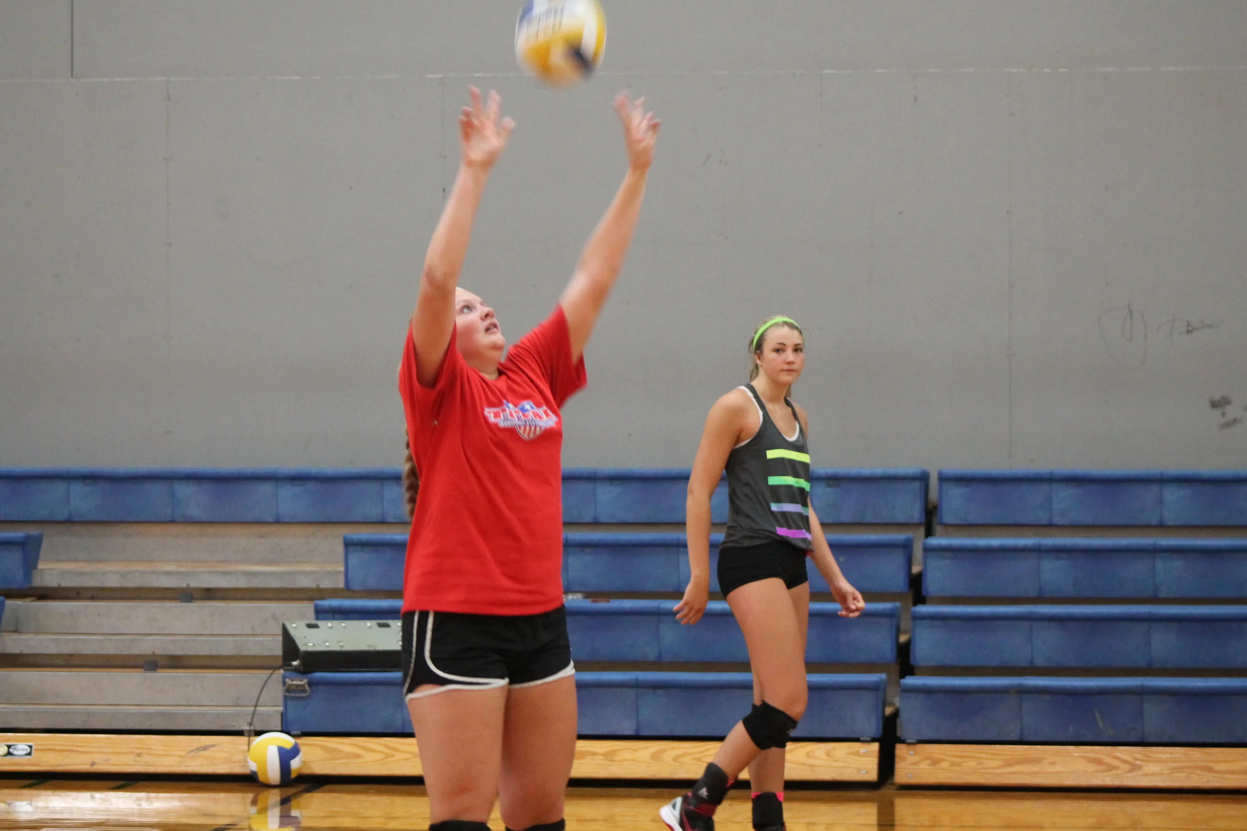 Bill Jones sets the ball as Bailey Foy watches during a practice at North Lamar gym.