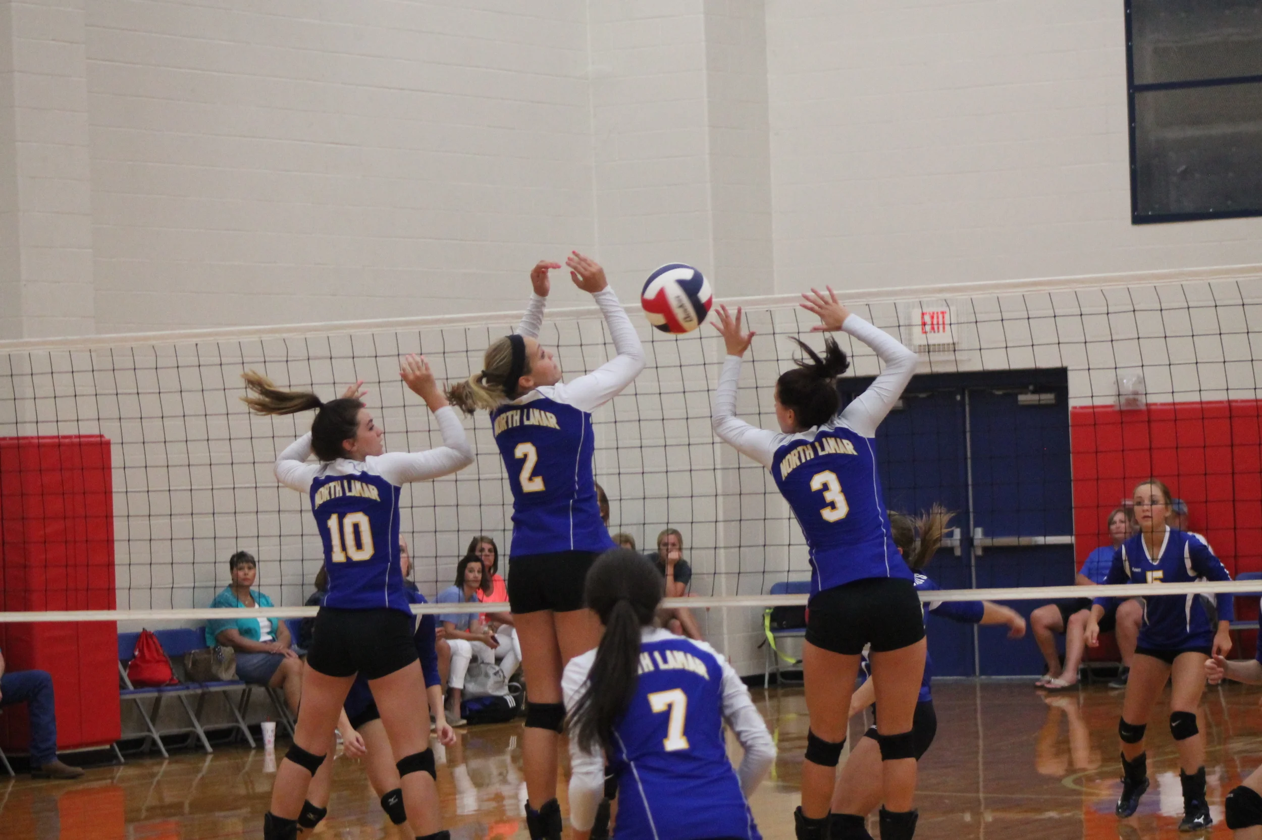 Mara Mabry (10), Jaycie McFatridge (2) and Katee Garrett going for up a block as Mary Gilbert (7) watches.