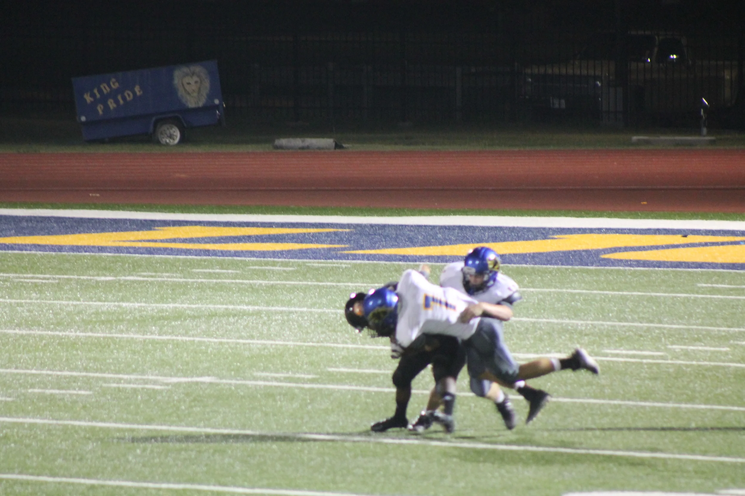 (Photo by Maddy Routon) Trey Scudder (7) and Klayton Drake bringing down a Commerce Player Friday night.