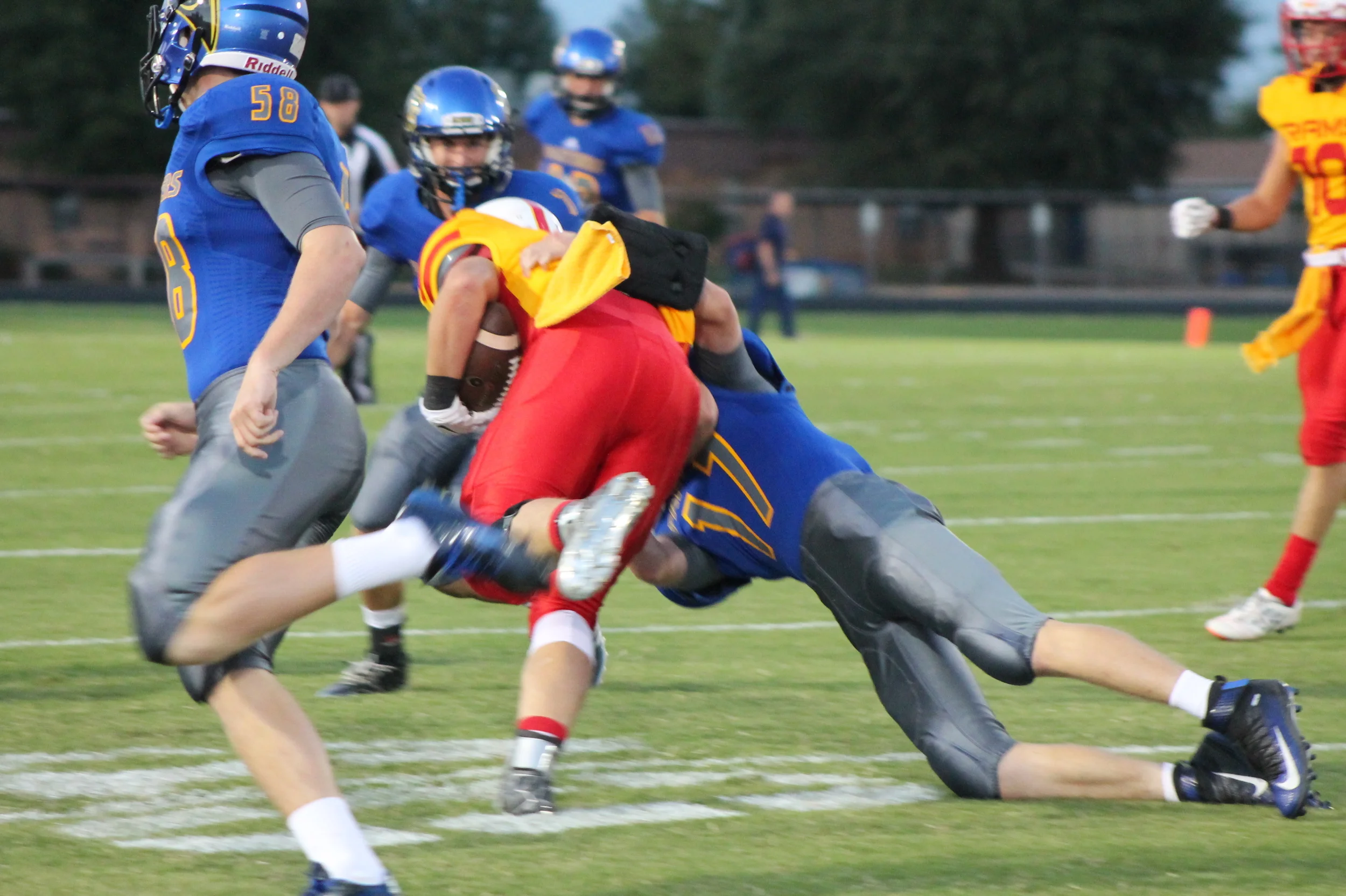 (Photo by Adam Routon) Tyler Biard (17) making a tackle for North Lamar against S&S as Klayton drake (58) looks on.