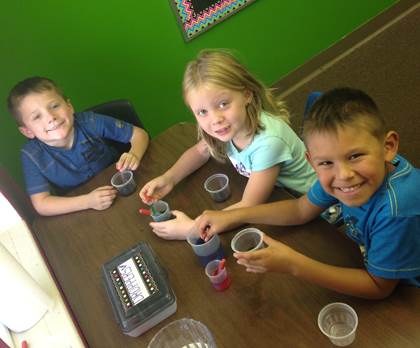 Higgins Elementary first grade students Brenton Upchurch, Sarah Chrisman, and Josiah Bond work on an experiment in science class. Kindergarten and first grade students at Higgins change classes during the day for their subject areas. 