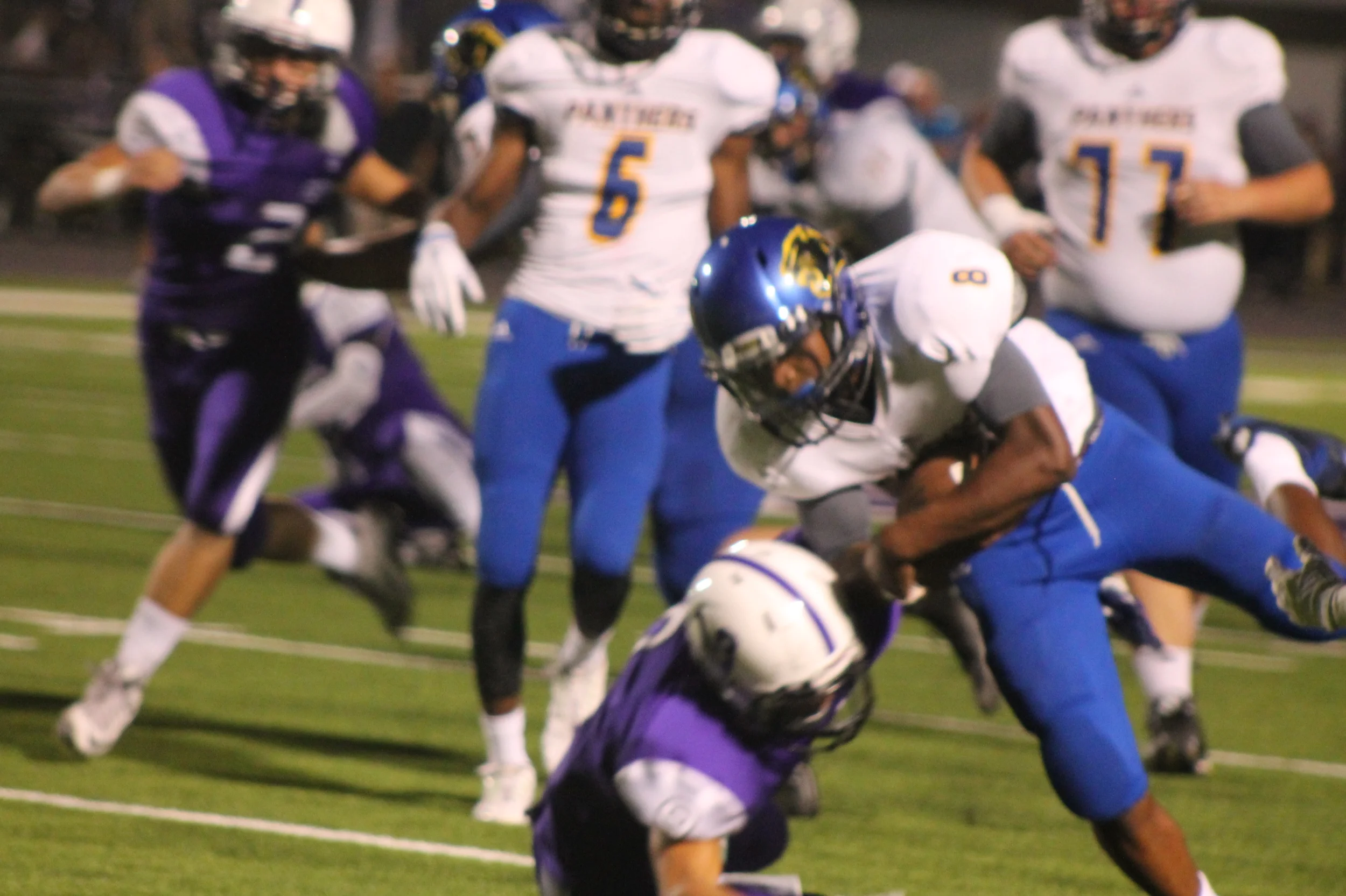 (photo by Maddy Routon) Tyler Hill (8) running through a tackle Friday night.