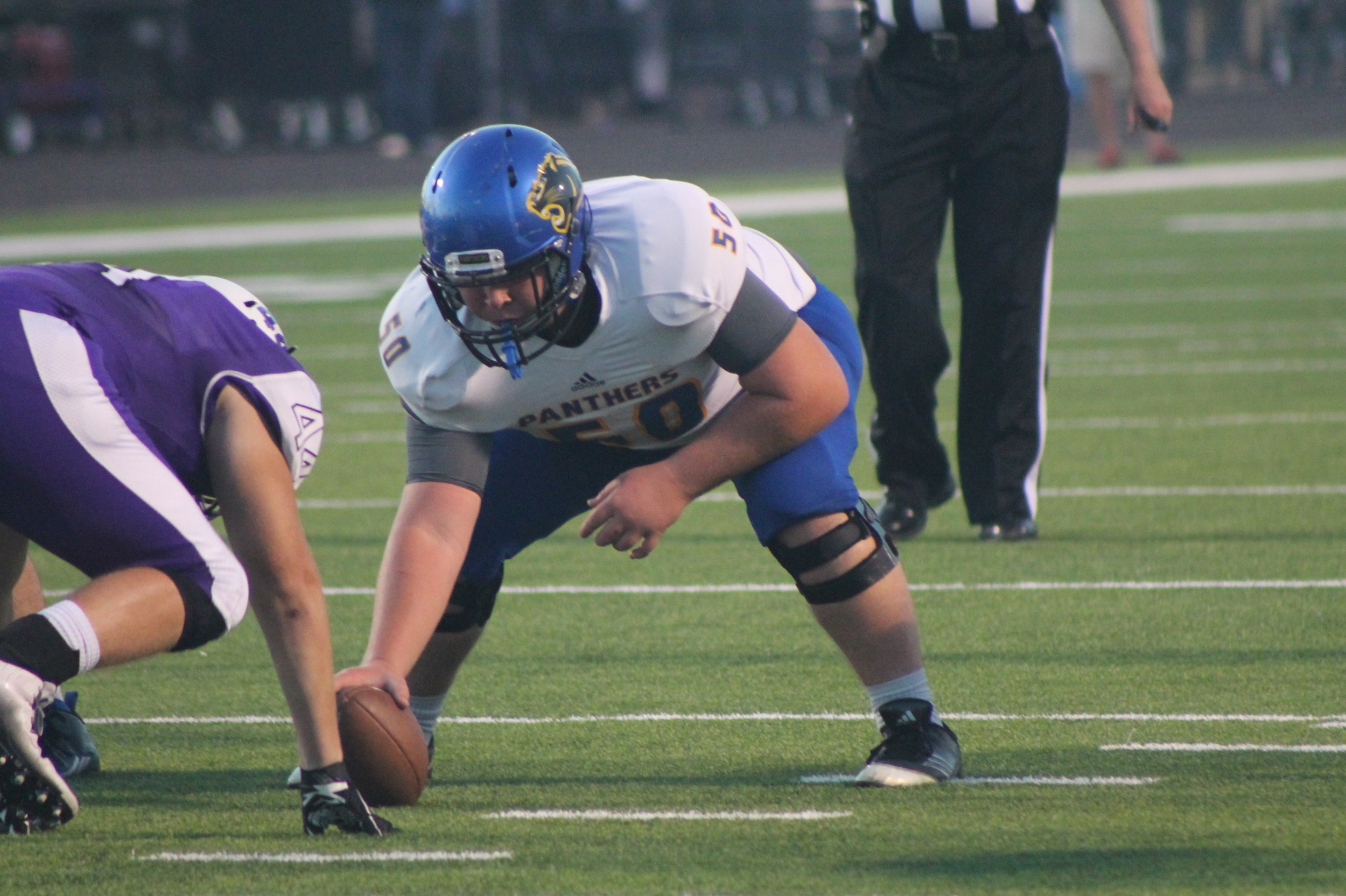 (Photo by Maddy Routon) Center Jansen Spann getting ready to snap the ball against Anna.