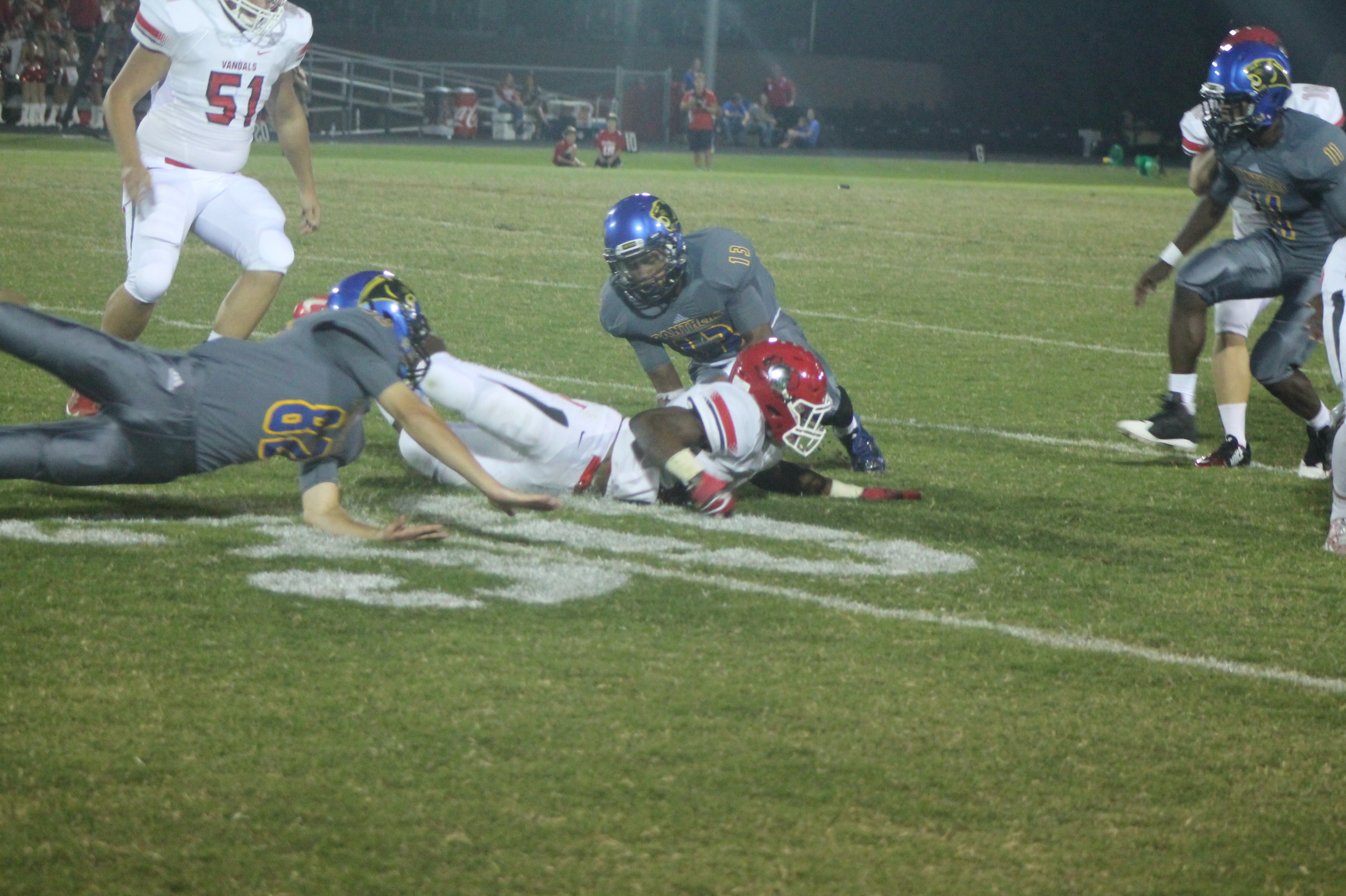 (Photo by Maddy Routon) Seybian Holt (13) recovers a fumbled kickoff while Jack Hill (82) goes diving in for the ball as well.