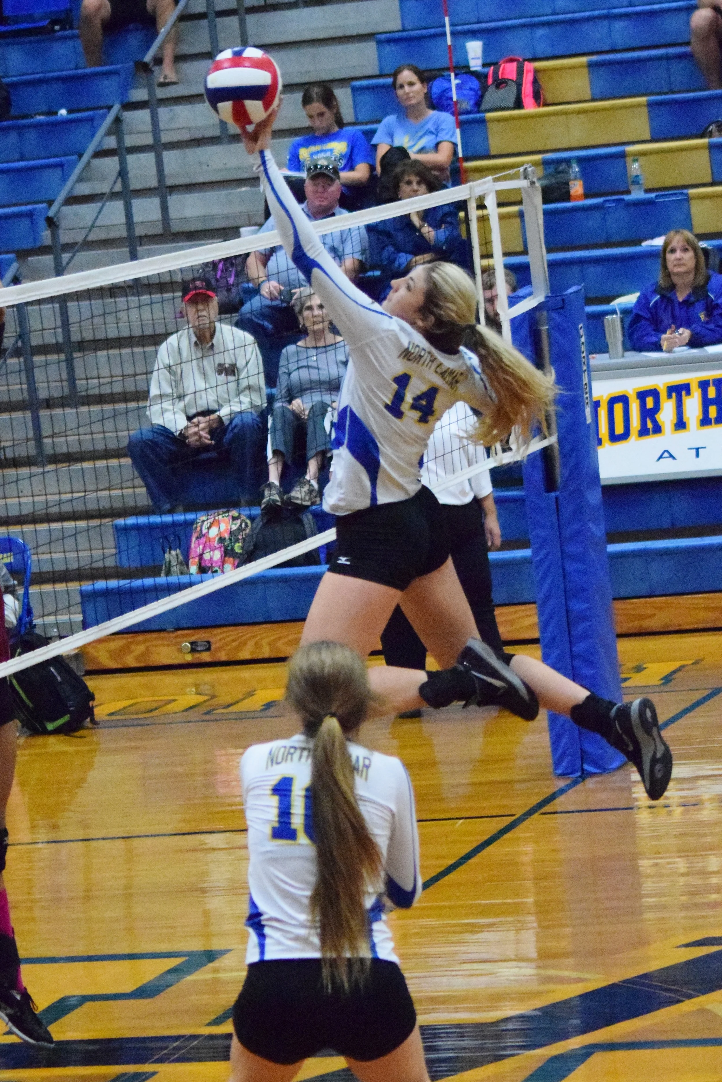 (Photo by Beverly White) Bailey Foy (14) taps the ball over as Bailee Nickerson (10) watches. 