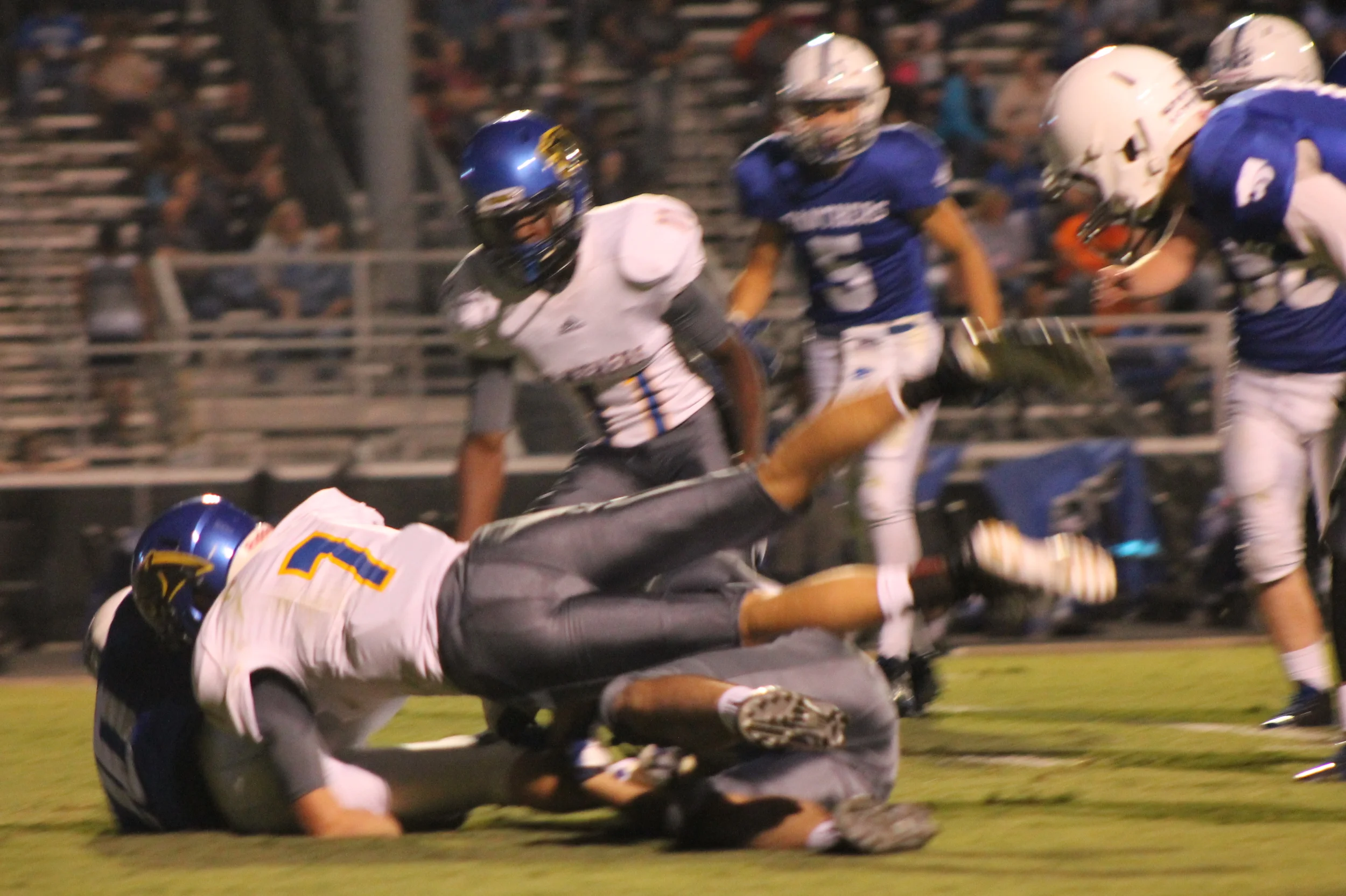 (Photo by Maddy Routon) Trey Scudder (7) making a tackle Friday night as Stephon Bass (11) watches.