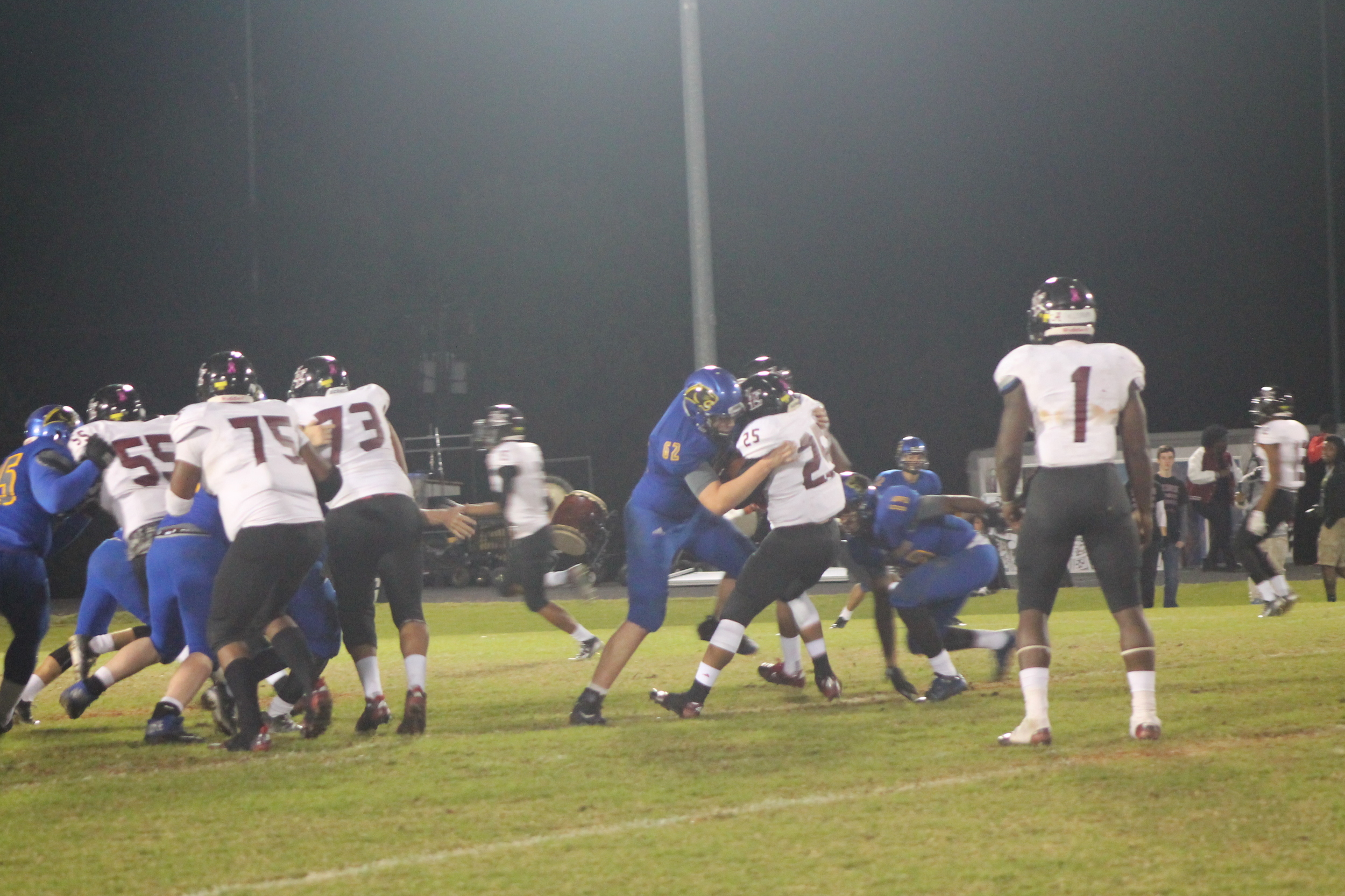(Photo by Adam Routon) North Lamar's defense making a play on the LE running back.