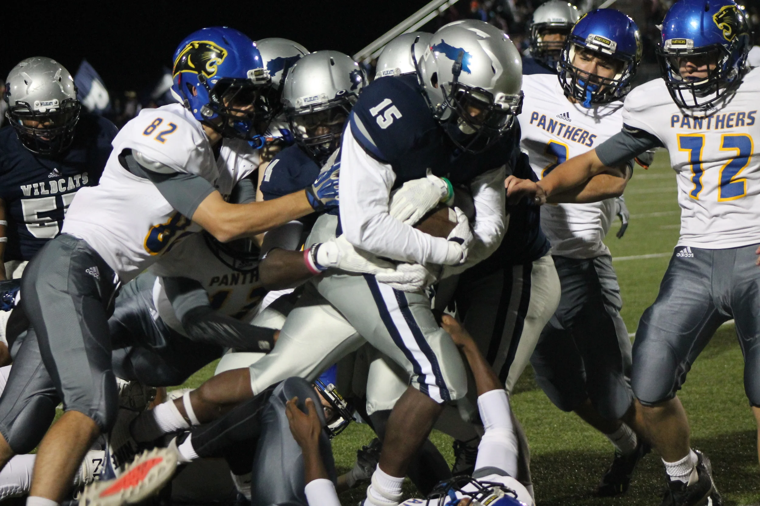 (Photo by Maddy Routon) North Lamar defense trying to bring down T.D. Williams of Paris High.