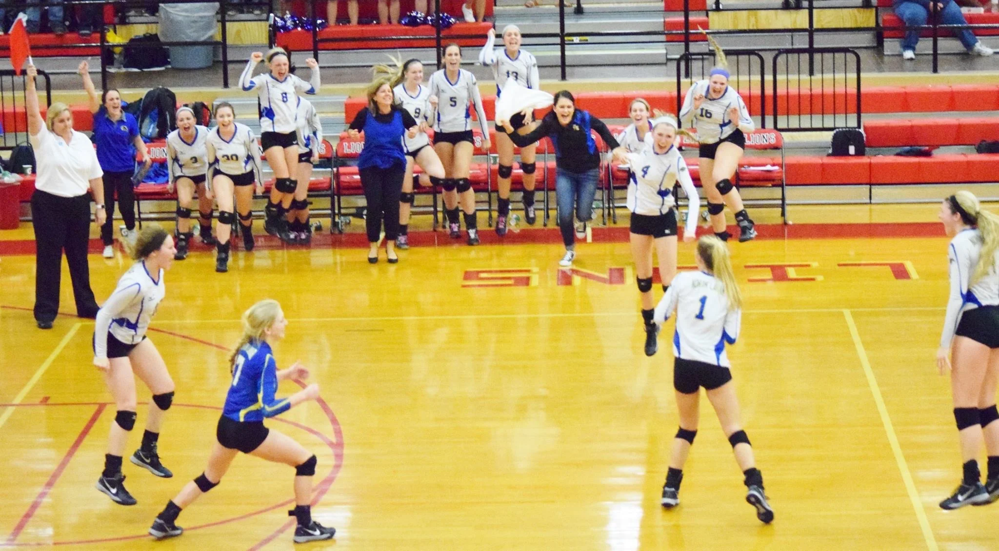 (photo by Beverly White) North Lamar celebrating the final point in their Area Round victory over Emory Rains.