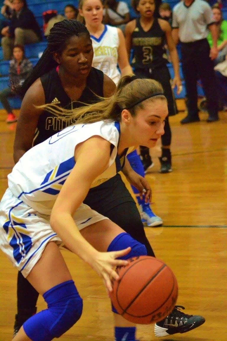 (Photo by Bev White) Madison Morrison driving past a defender Tuesday night