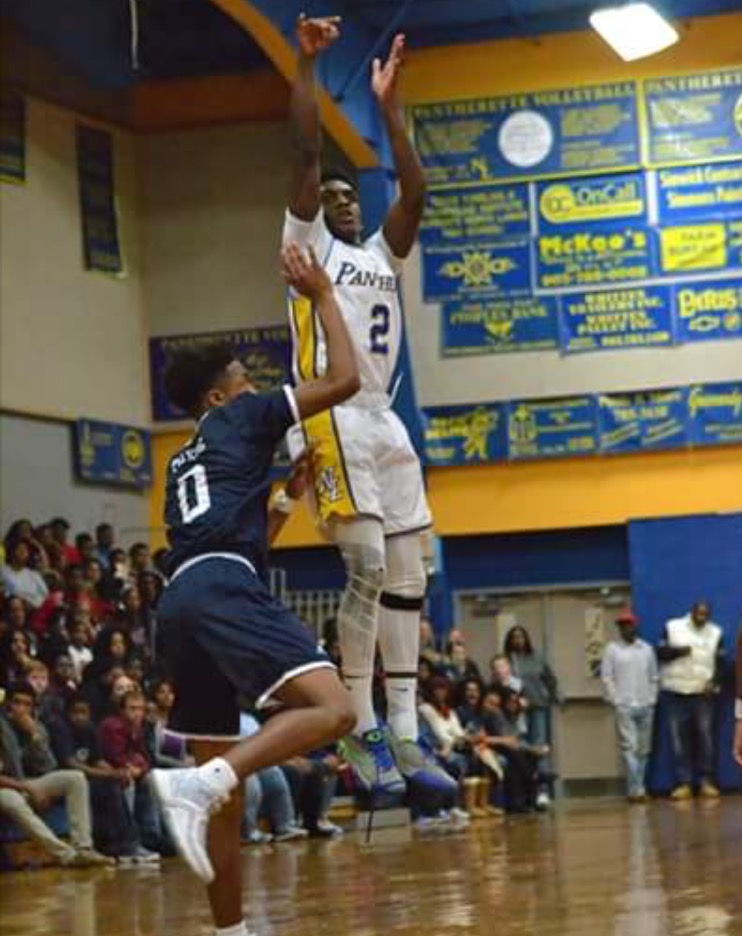 (Photo by Beveryly White) Versache Buchanan with a three-point attempt against Paris