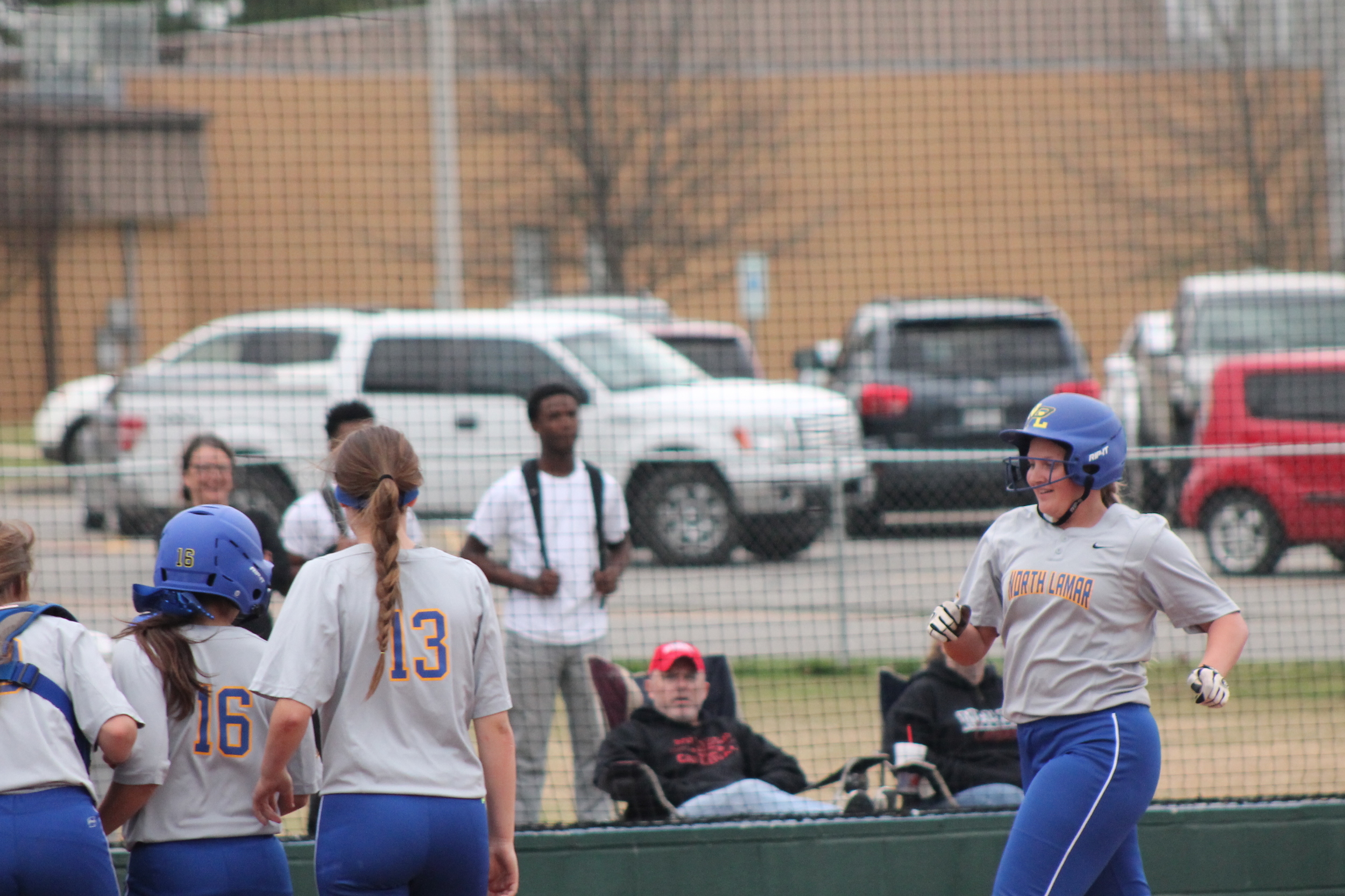 Bill Jones being greeted by her teammates after a three-run homer against Melissa