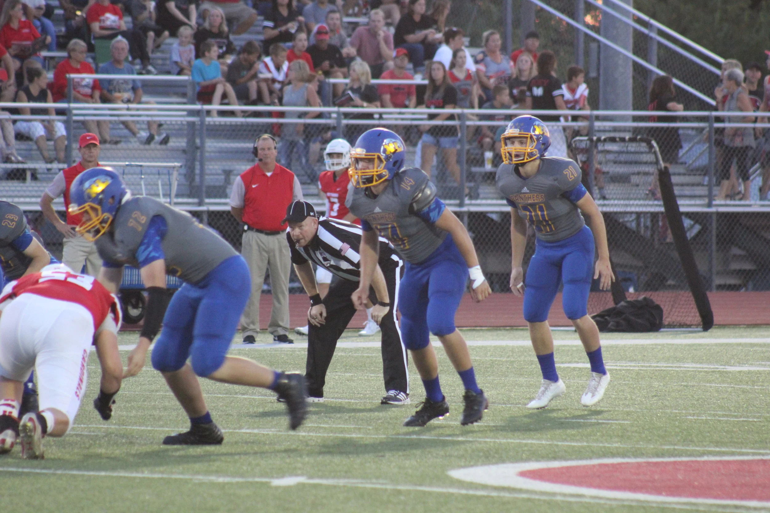 (Photo by Maddy Routon) Ty Waggoner (14), Jeremiah Guenther (21) and Monty Ponder (72) waiting for the ball to be snapped by Pottsboro.