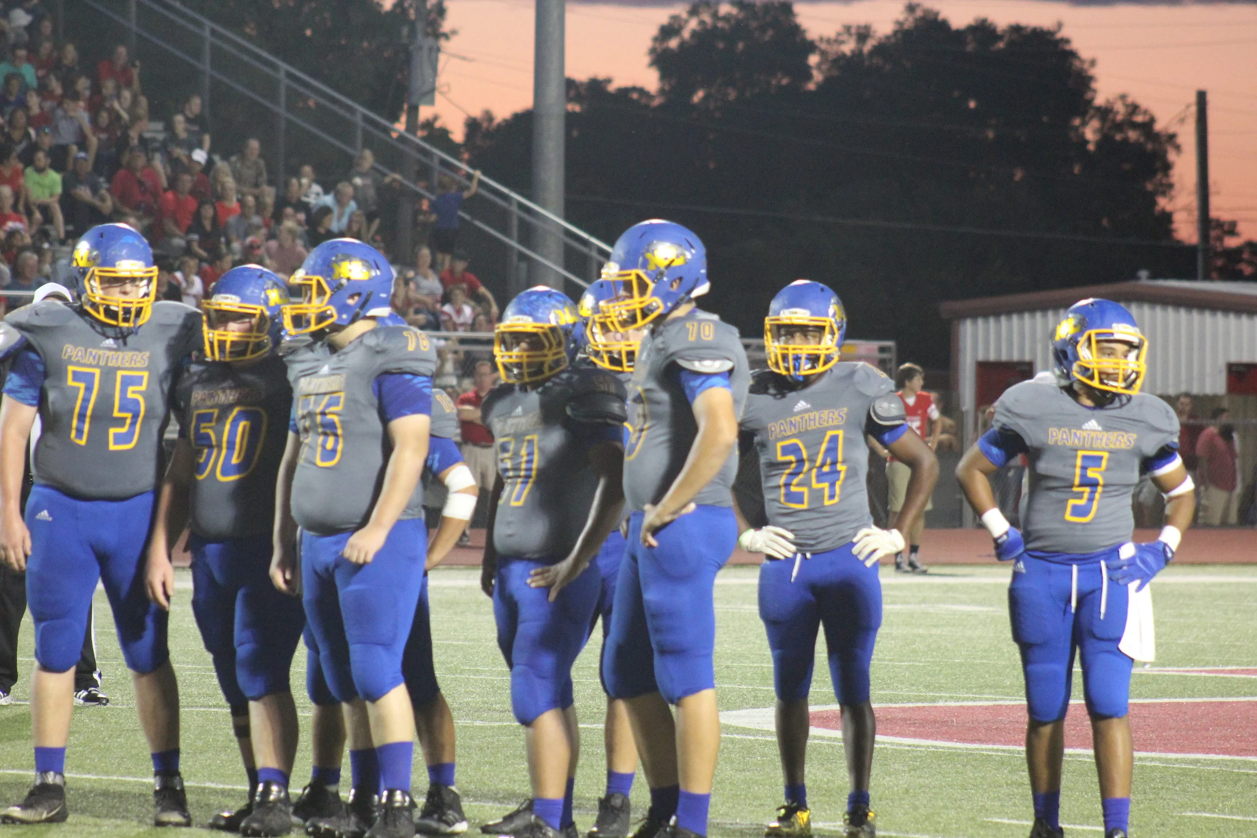 (Photo by Maddy Routon) The North Lamar offense waiting on a play from the sideline.