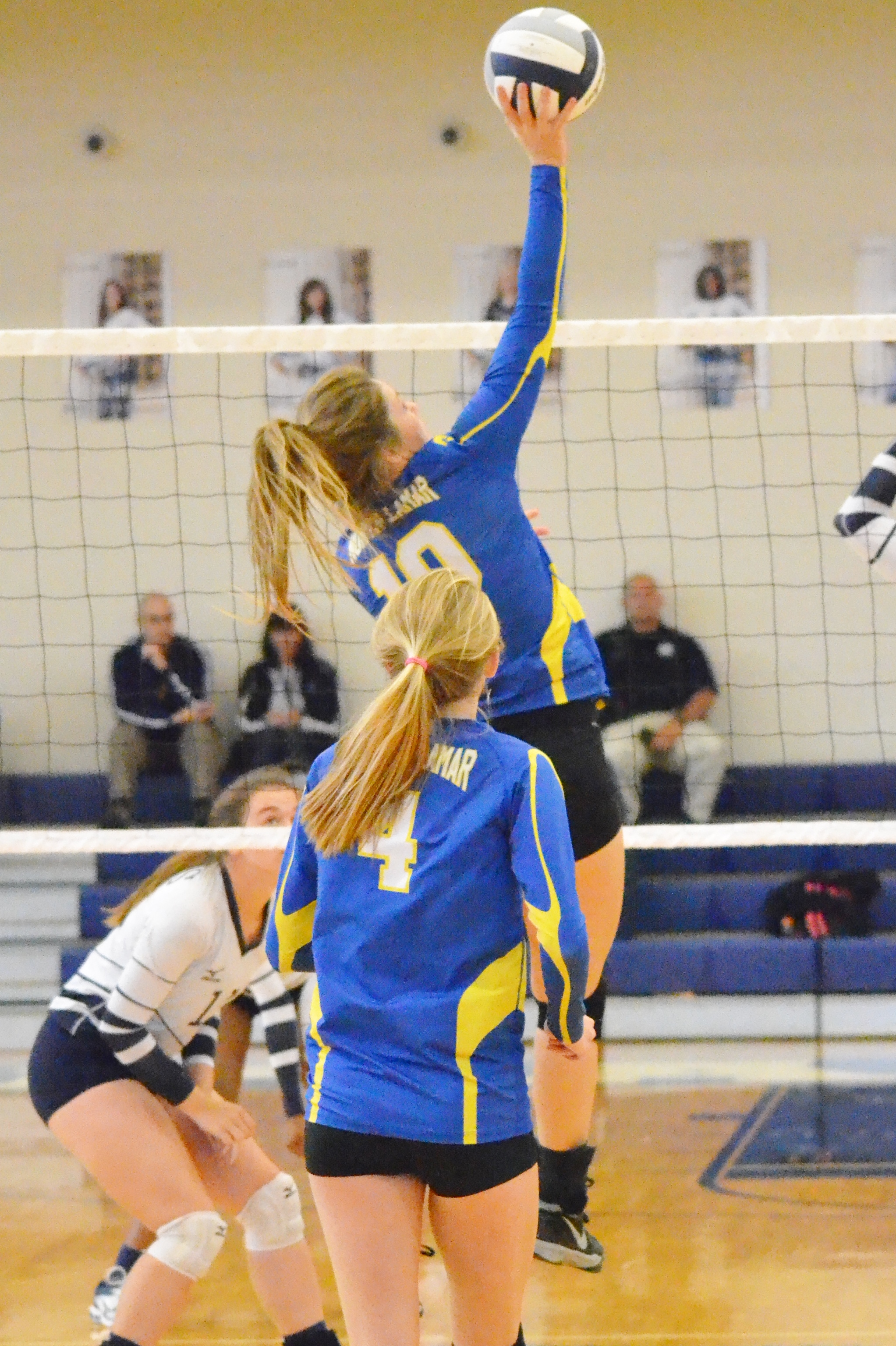 (Photo by Beverly White) Bailee Nickerson (10) hitting the ball over the net while Karlie Ewell (4) looks on. 